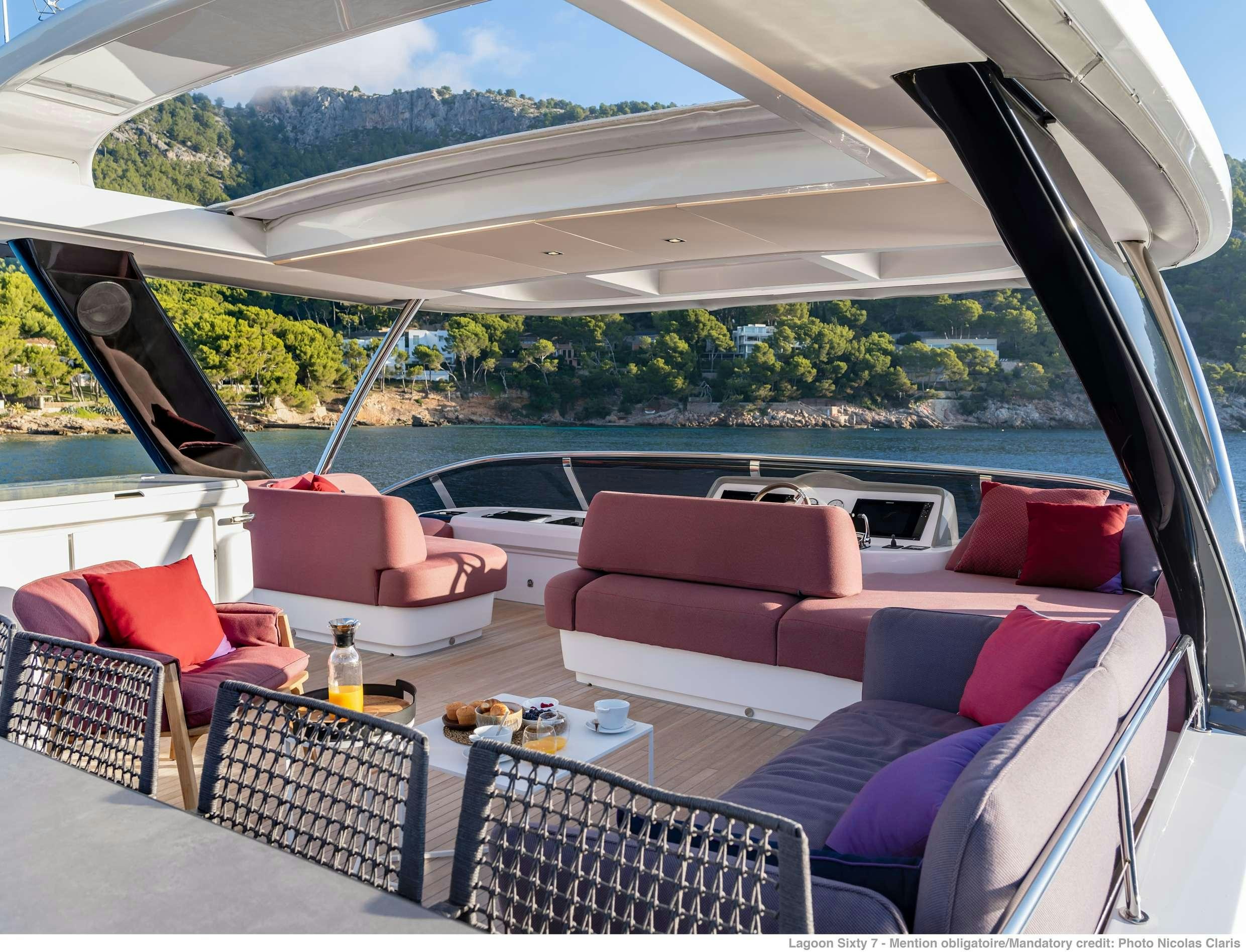 a large living room with a large patio and a large pool aboard VALIUM 67 Yacht for Charter