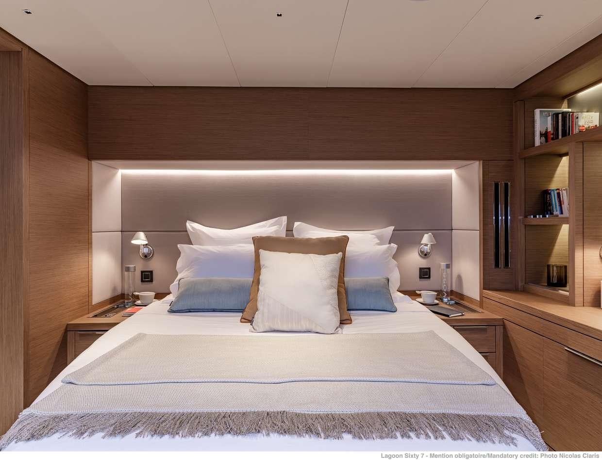 a bed with pillows aboard VALIUM 67 Yacht for Charter
