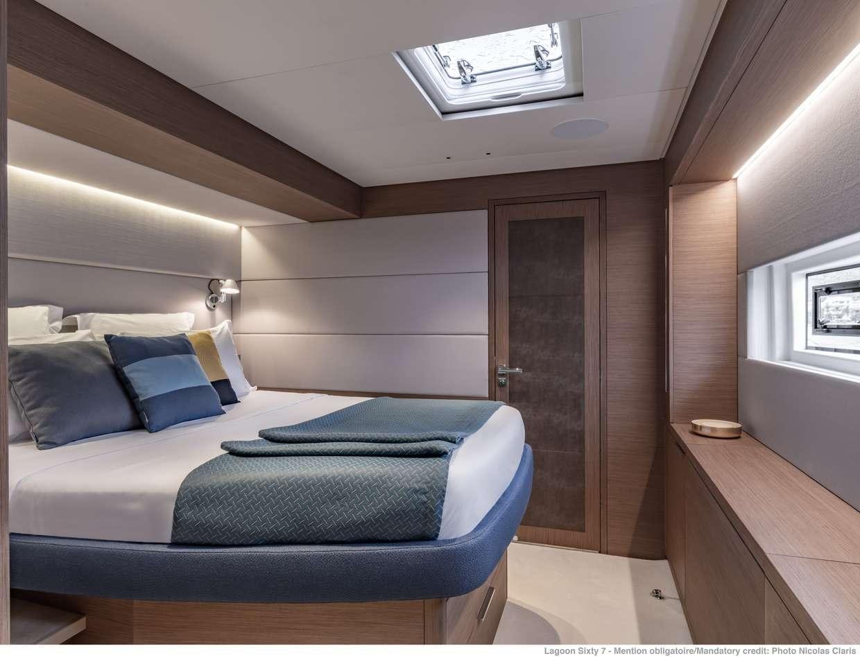 a room with a bed and a desk aboard VALIUM 67 Yacht for Charter