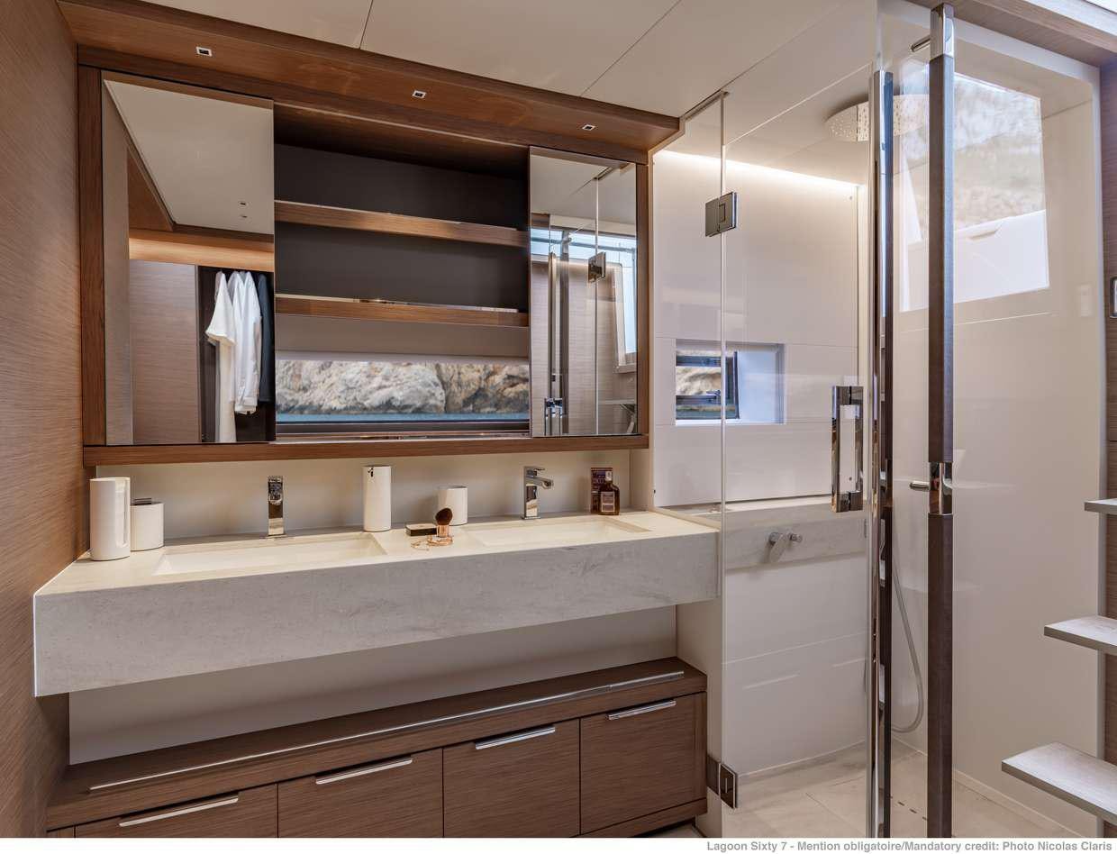 a bathroom with a sink and a mirror aboard VALIUM 67 Yacht for Charter