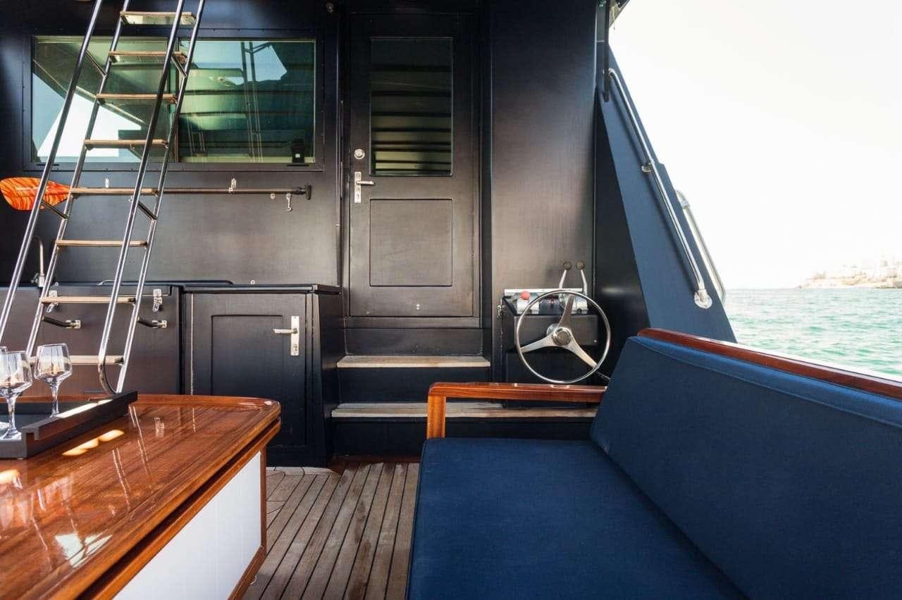 a boat with a table and chairs aboard Theoxenia Yacht for Charter