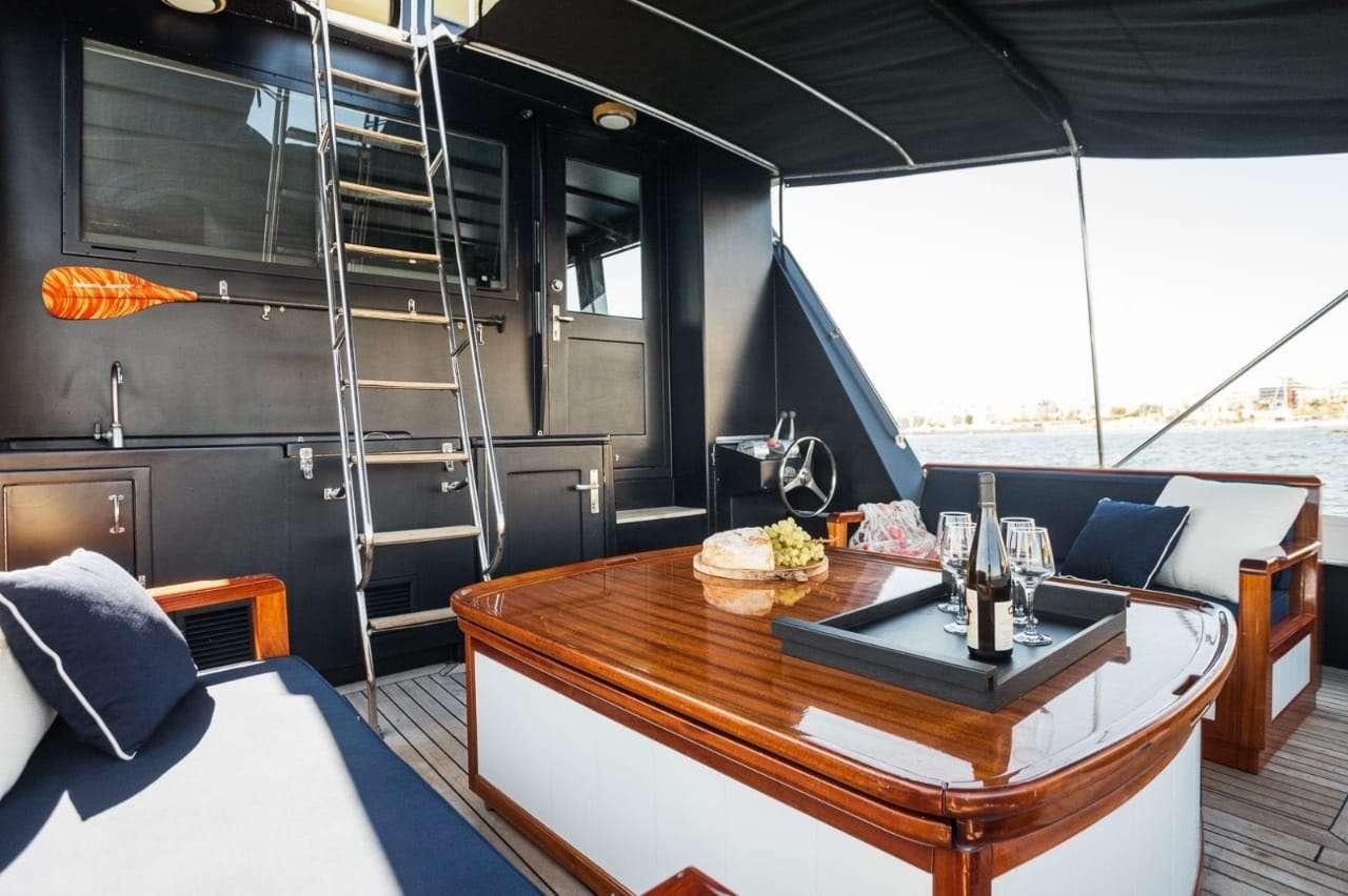 a table with wine glasses on it aboard Theoxenia Yacht for Charter