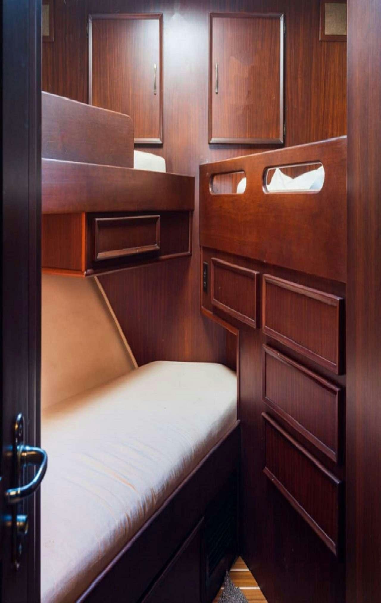 a wooden cabinet above a bed aboard Theoxenia Yacht for Charter