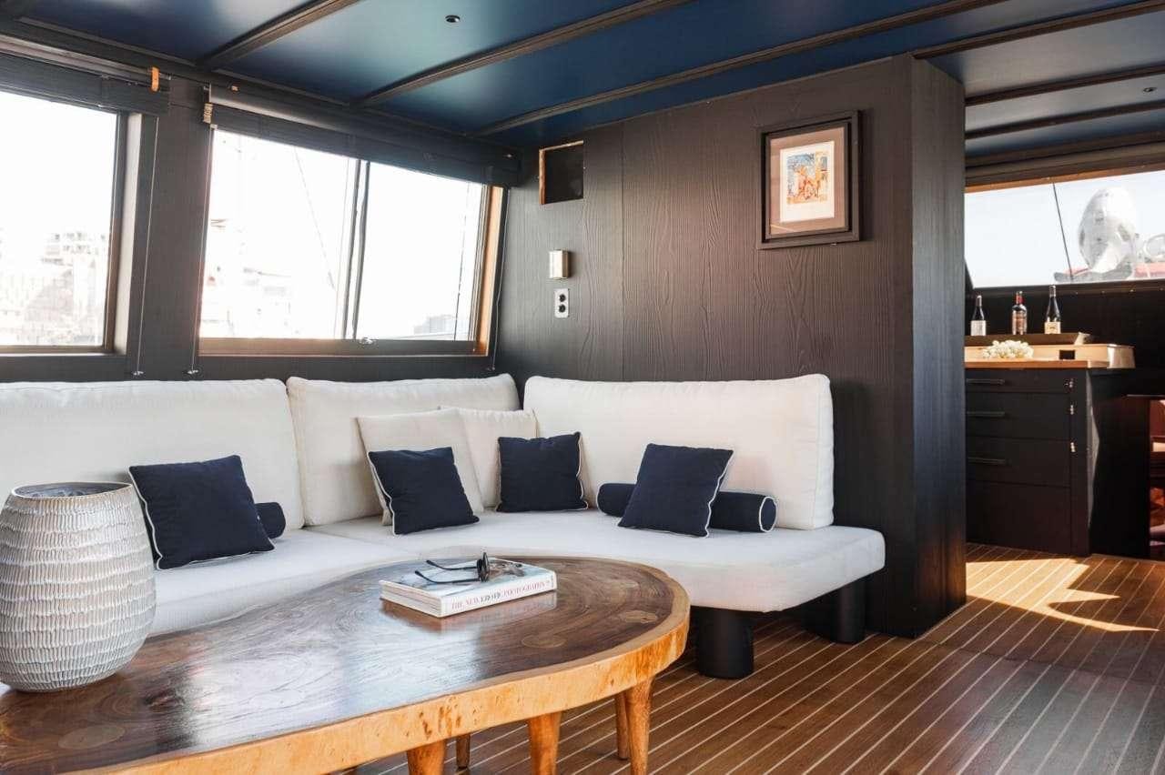 a living room with a white couch aboard Theoxenia Yacht for Charter