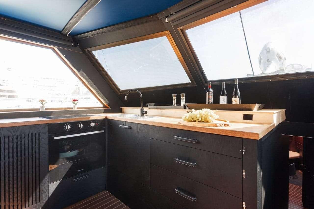 a kitchen with a large window aboard Theoxenia Yacht for Charter
