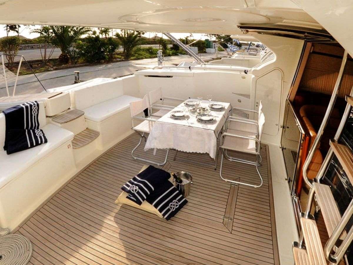 a room with a table and chairs aboard PALMYRA Yacht for Charter