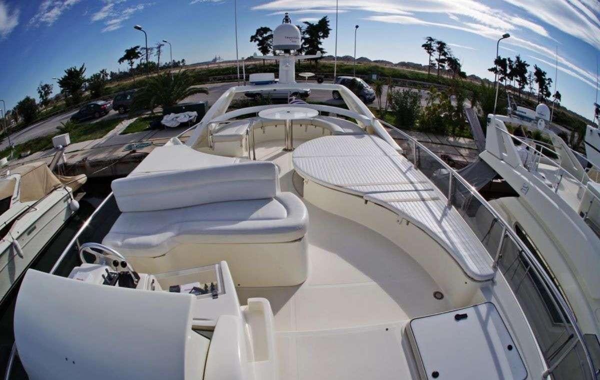 a group of white chairs on a beach aboard PALMYRA Yacht for Charter
