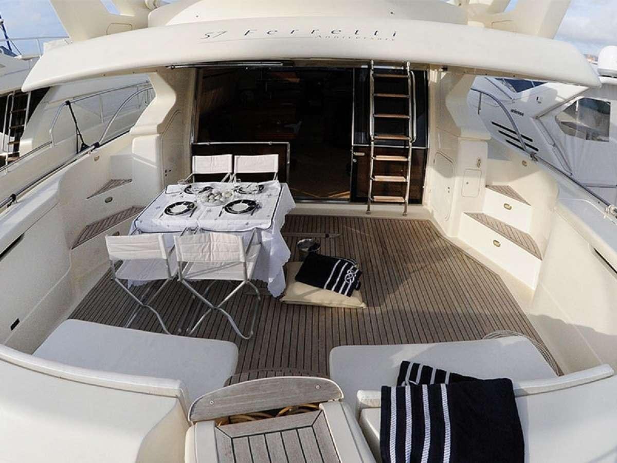a boat with a table and chairs aboard PALMYRA Yacht for Charter