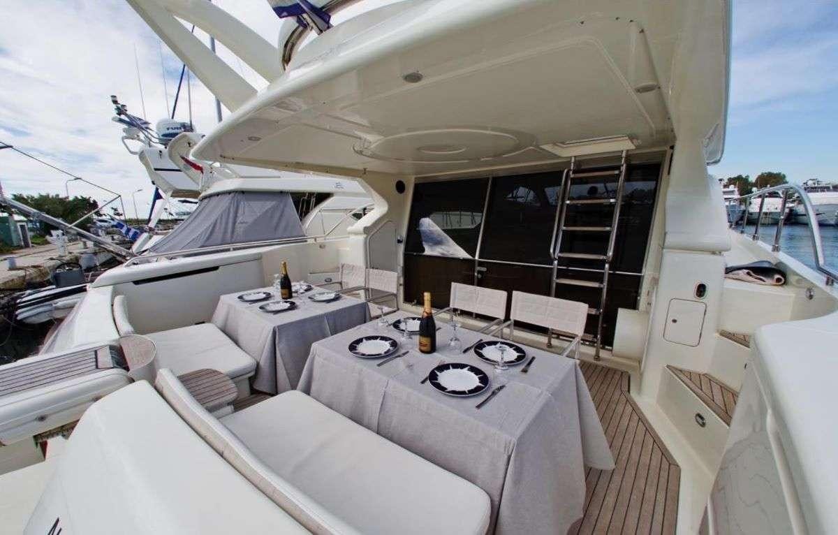 a boat with a table and chairs aboard PALMYRA Yacht for Charter