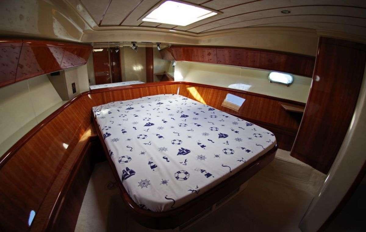 a bed in a room aboard PALMYRA Yacht for Charter