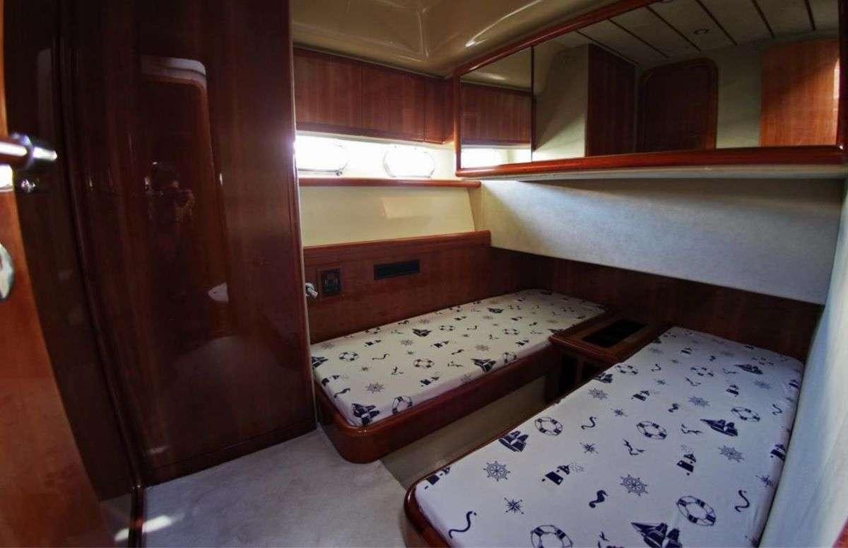 a room with a bed and a closet aboard PALMYRA Yacht for Charter