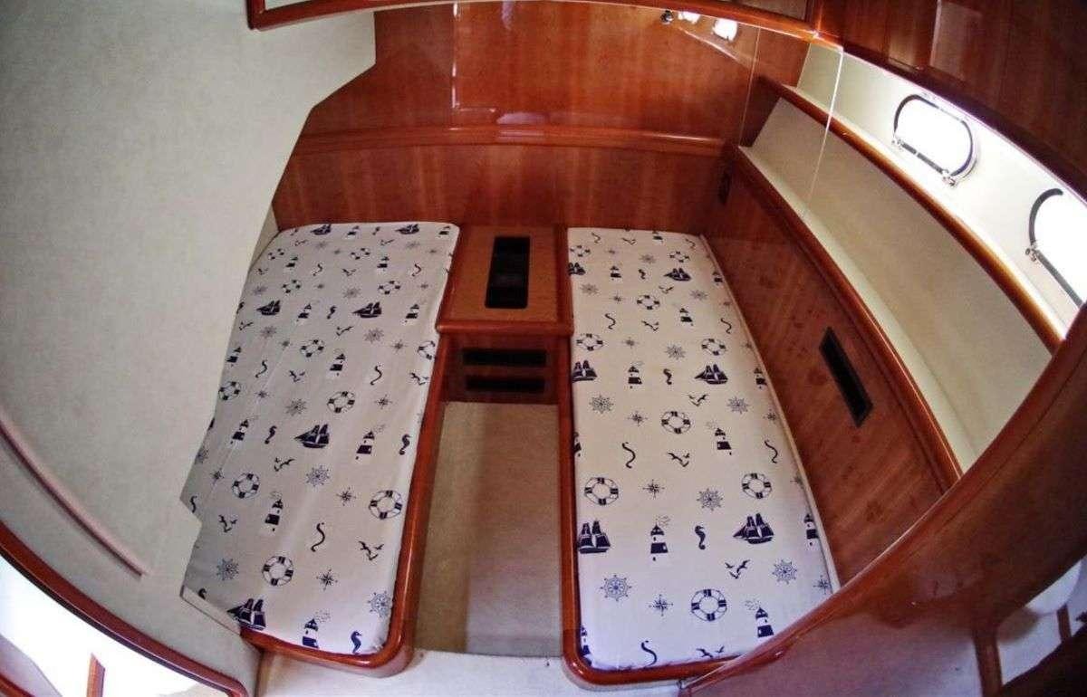 a table with chairs and a rug aboard PALMYRA Yacht for Charter