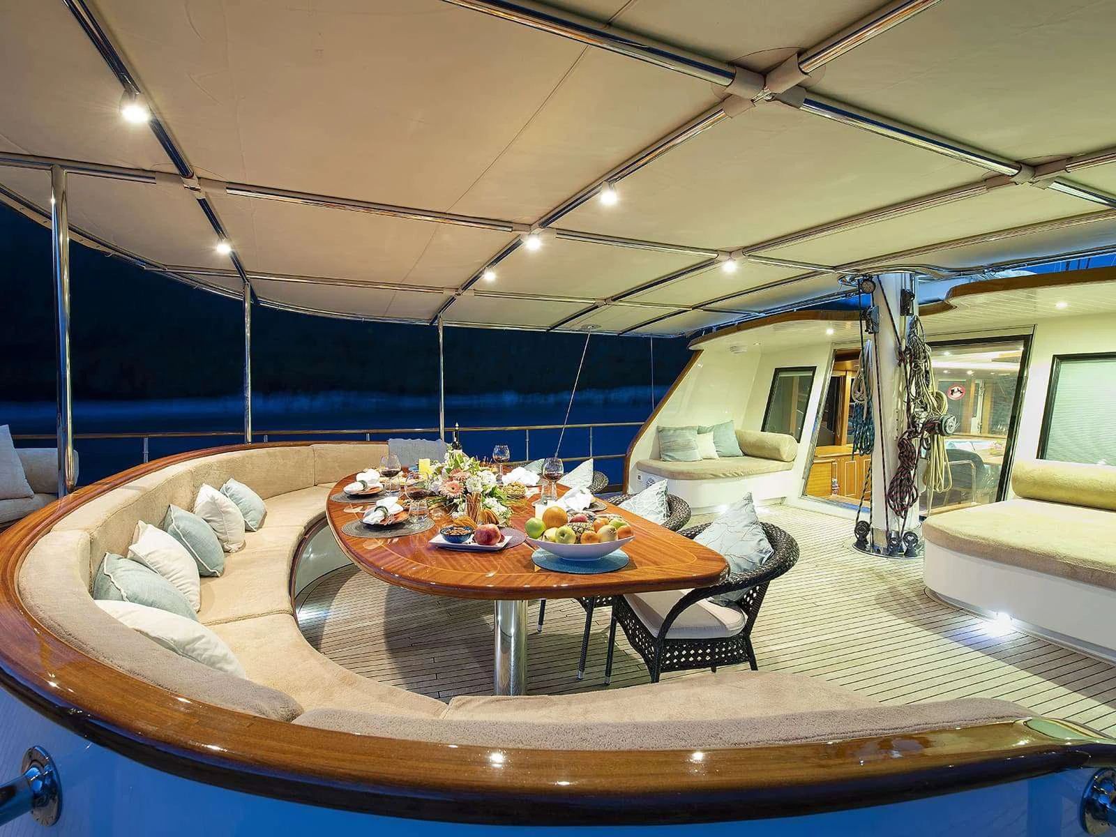 a large lounge area with a table and chairs aboard RIVA Yacht for Charter