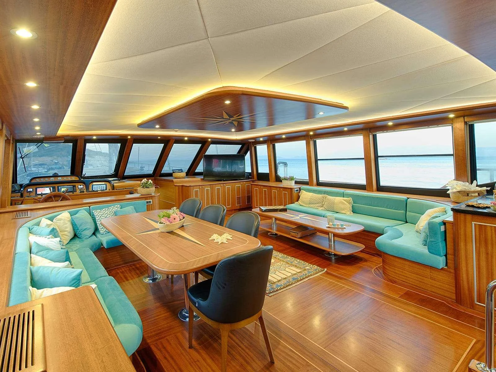 a room with a table and chairs aboard RIVA Yacht for Charter