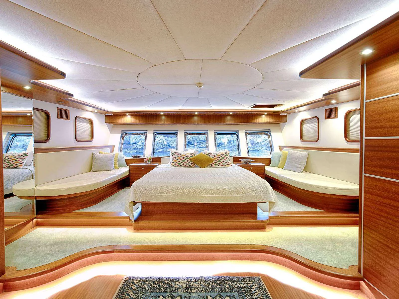 a room with a bed and a couch aboard RIVA Yacht for Charter
