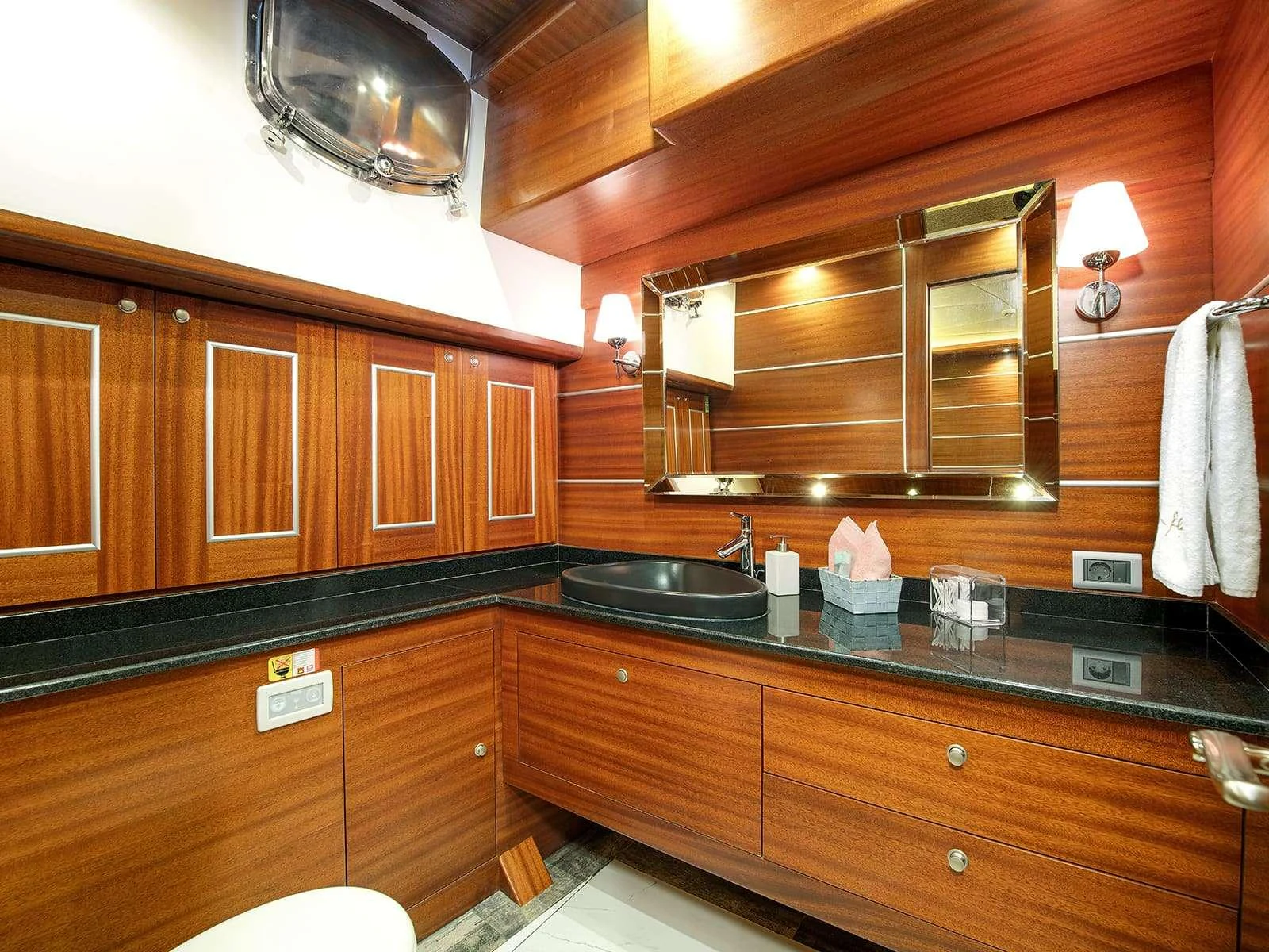 a kitchen with wooden cabinets aboard RIVA Yacht for Charter