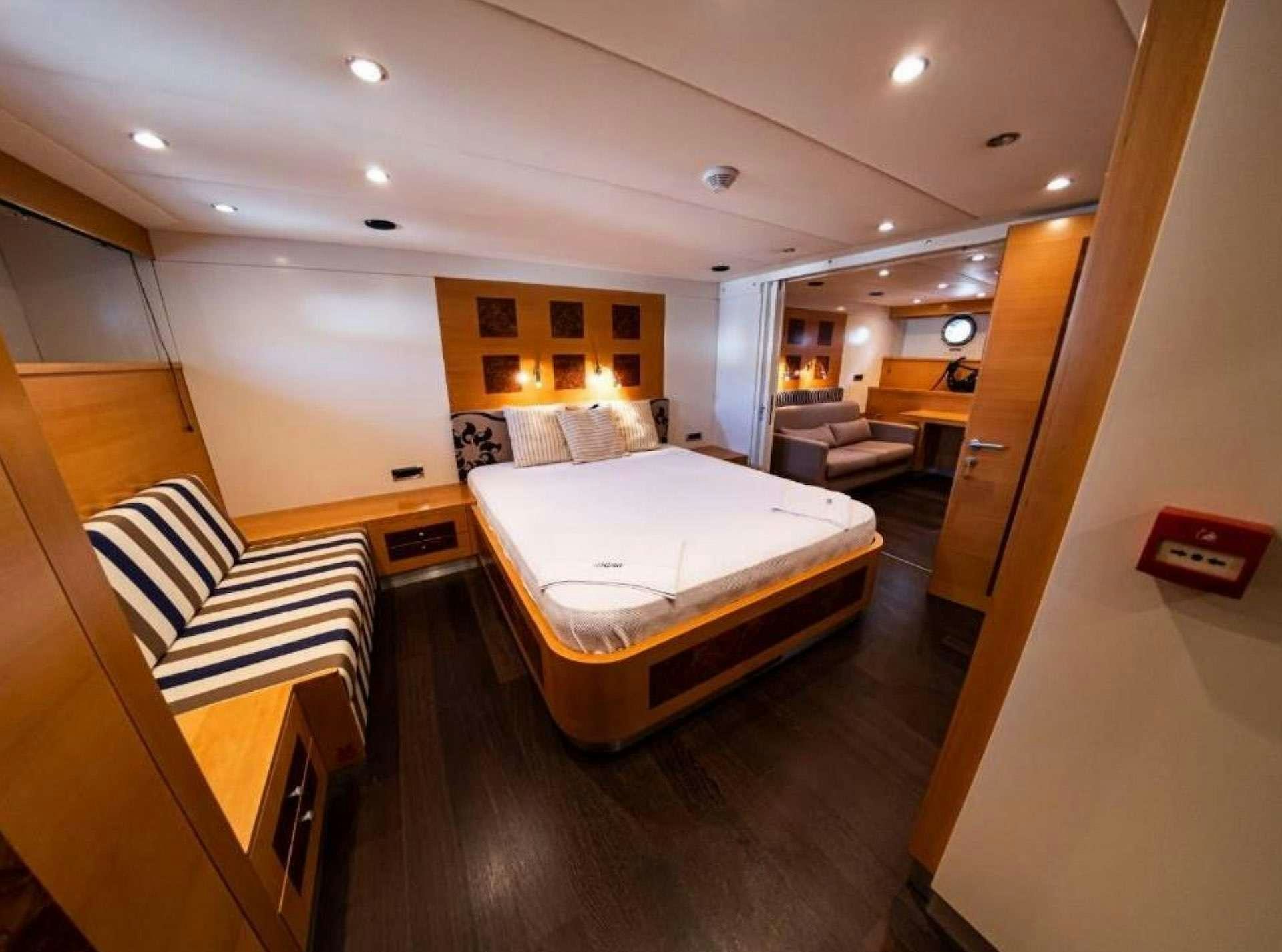 a room with a bed and a couch aboard TIGRA Yacht for Charter