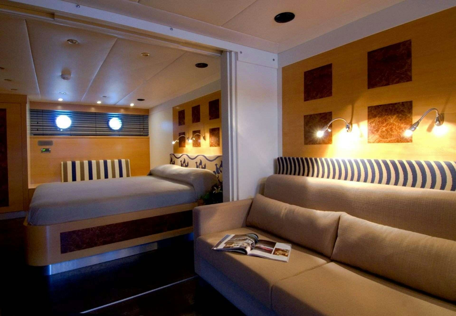 a living room with a couch and a bed aboard TIGRA Yacht for Charter