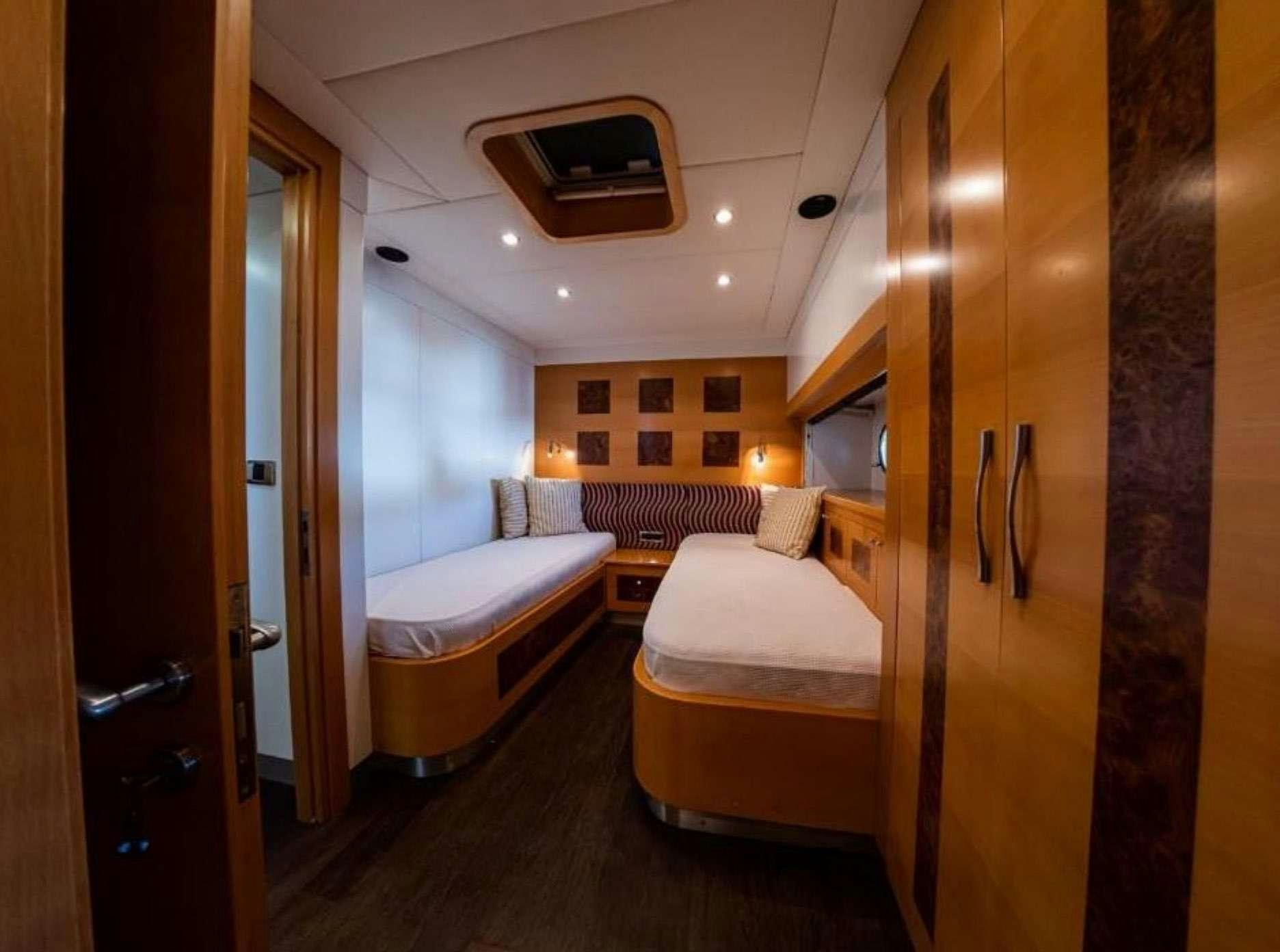 a room with a bed and a mirror aboard TIGRA Yacht for Charter