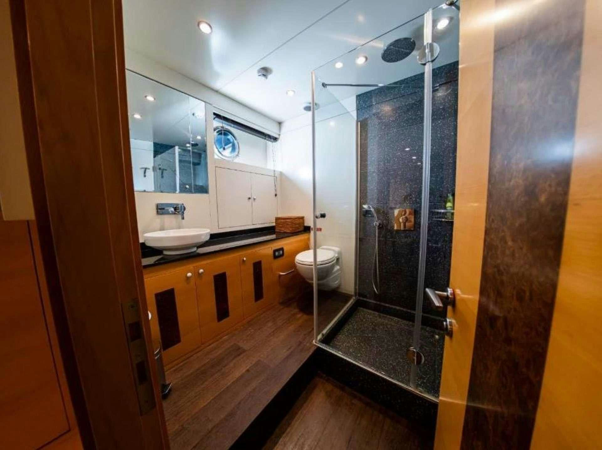 a bathroom with a glass shower aboard TIGRA Yacht for Charter