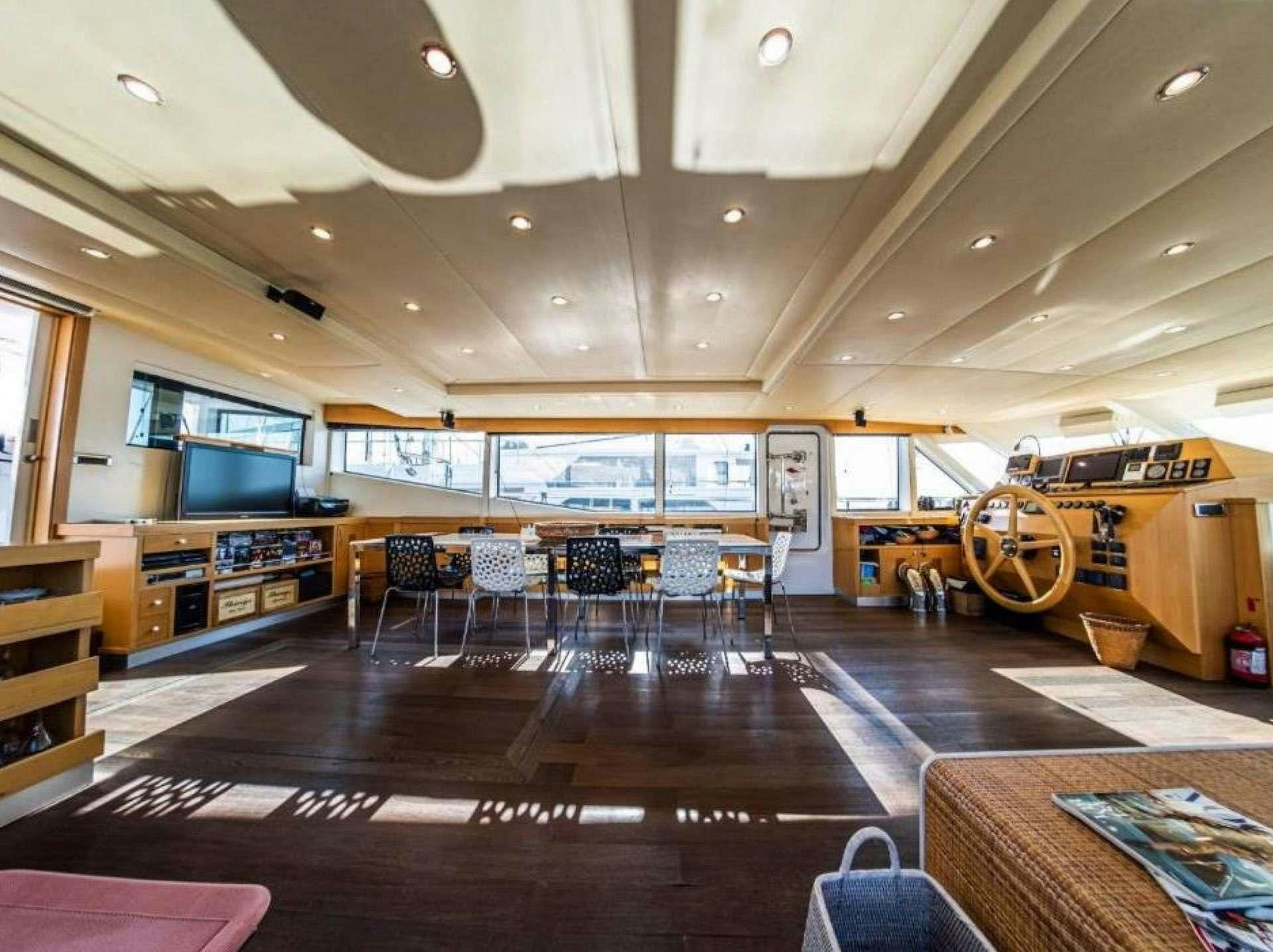 a large room with a wood floor and a large wood floor aboard TIGRA Yacht for Charter