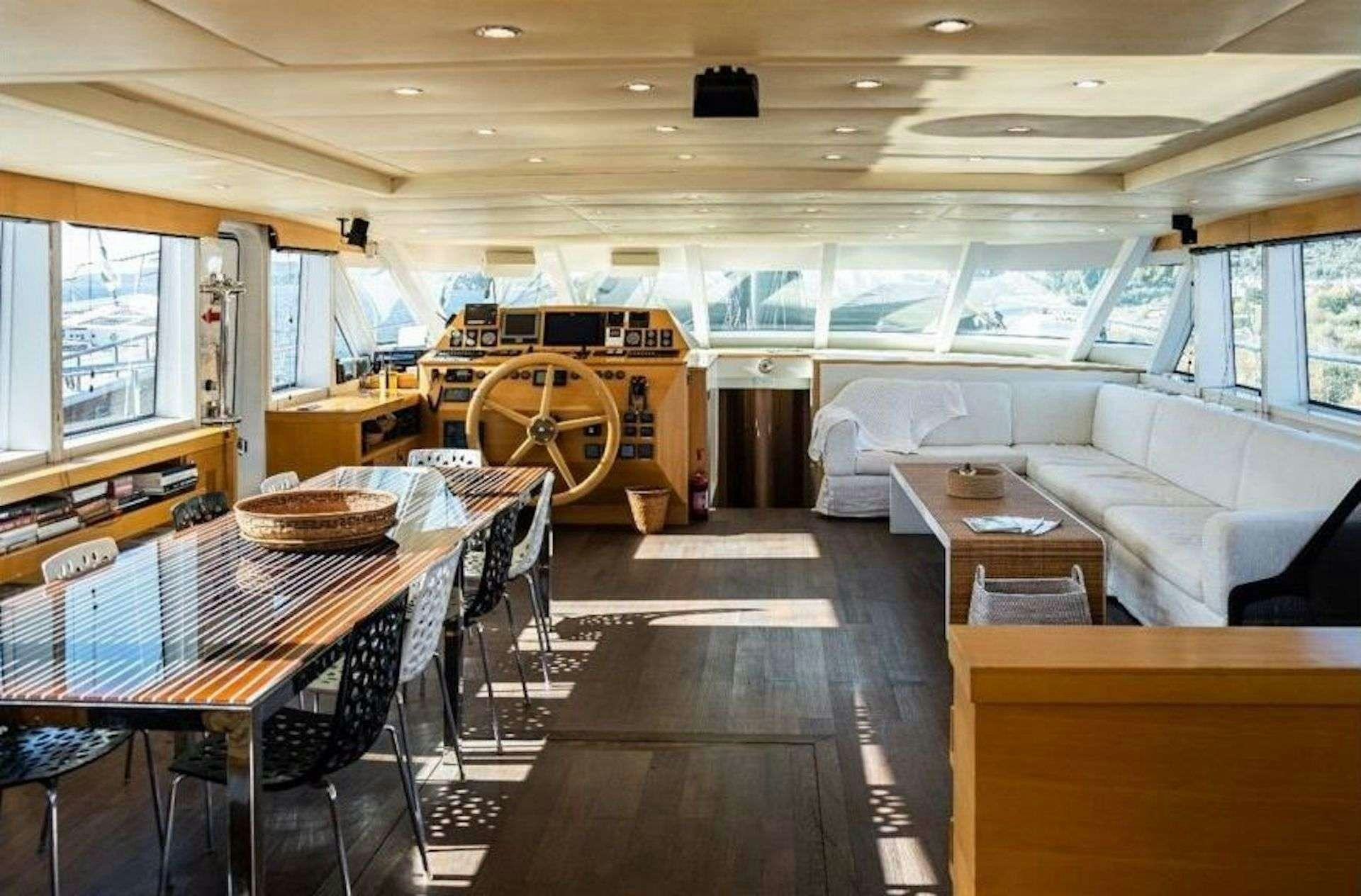 a large room with a table and chairs aboard TIGRA Yacht for Charter