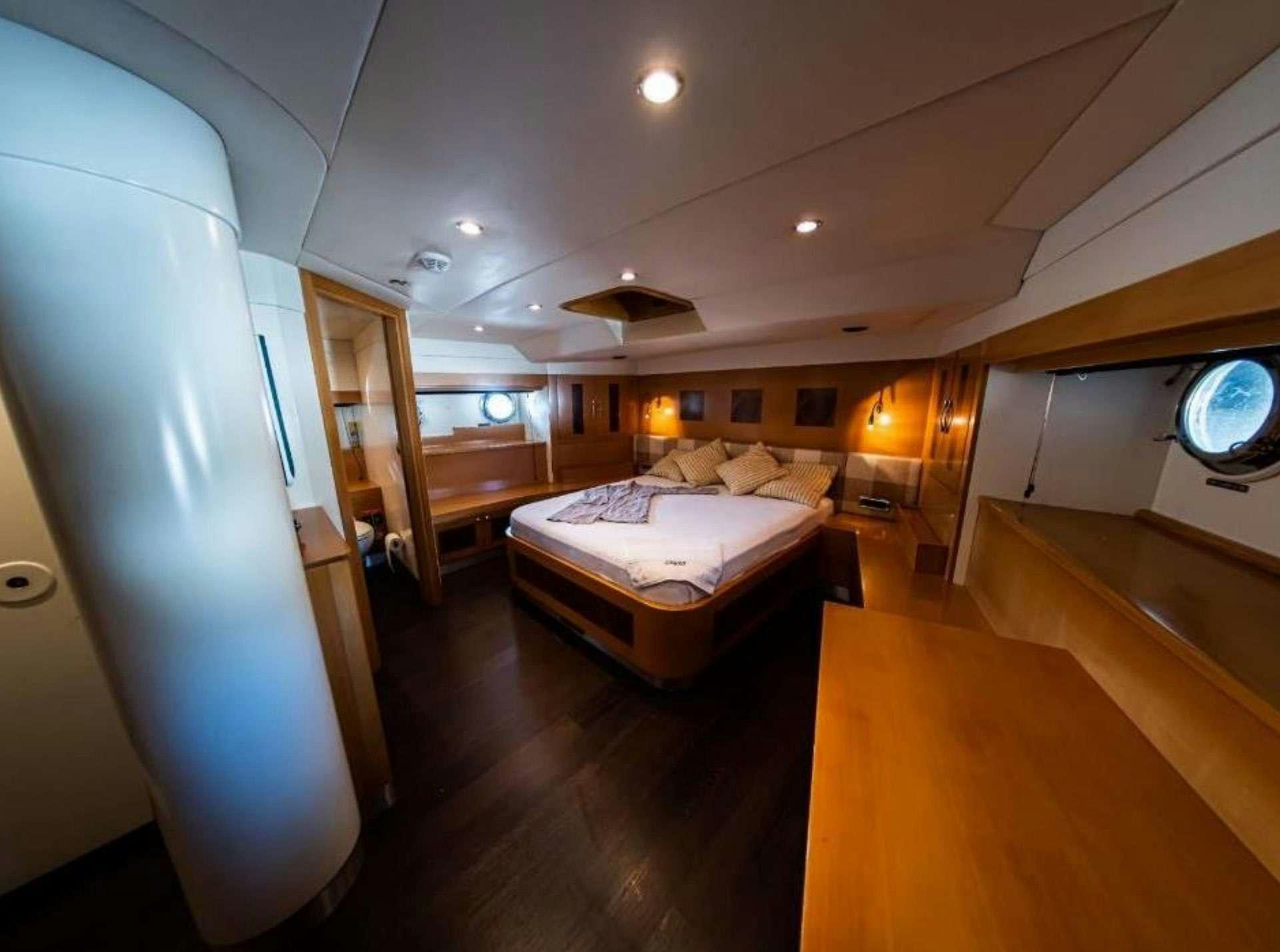 a bedroom with a bed and a large mirror aboard TIGRA Yacht for Charter