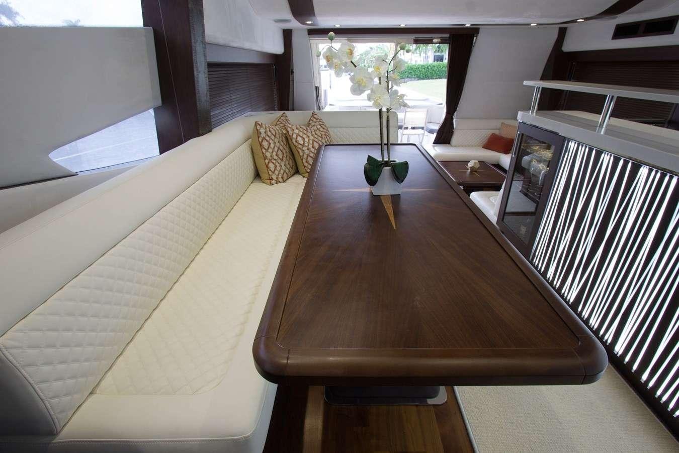 a room with a table and couch aboard MOODSWING Yacht for Charter