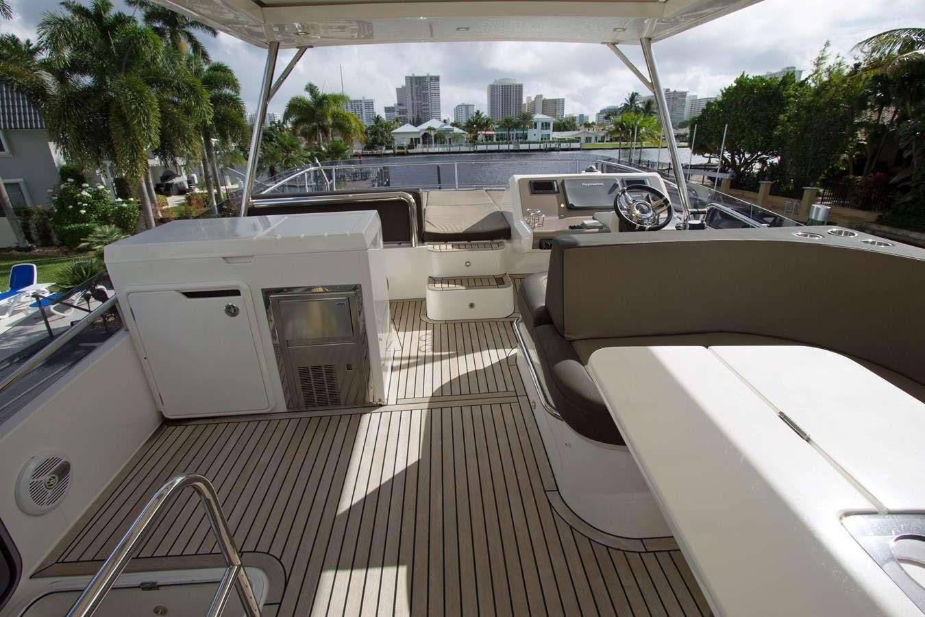 a deck with a deck and a view of a city aboard MOODSWING Yacht for Charter