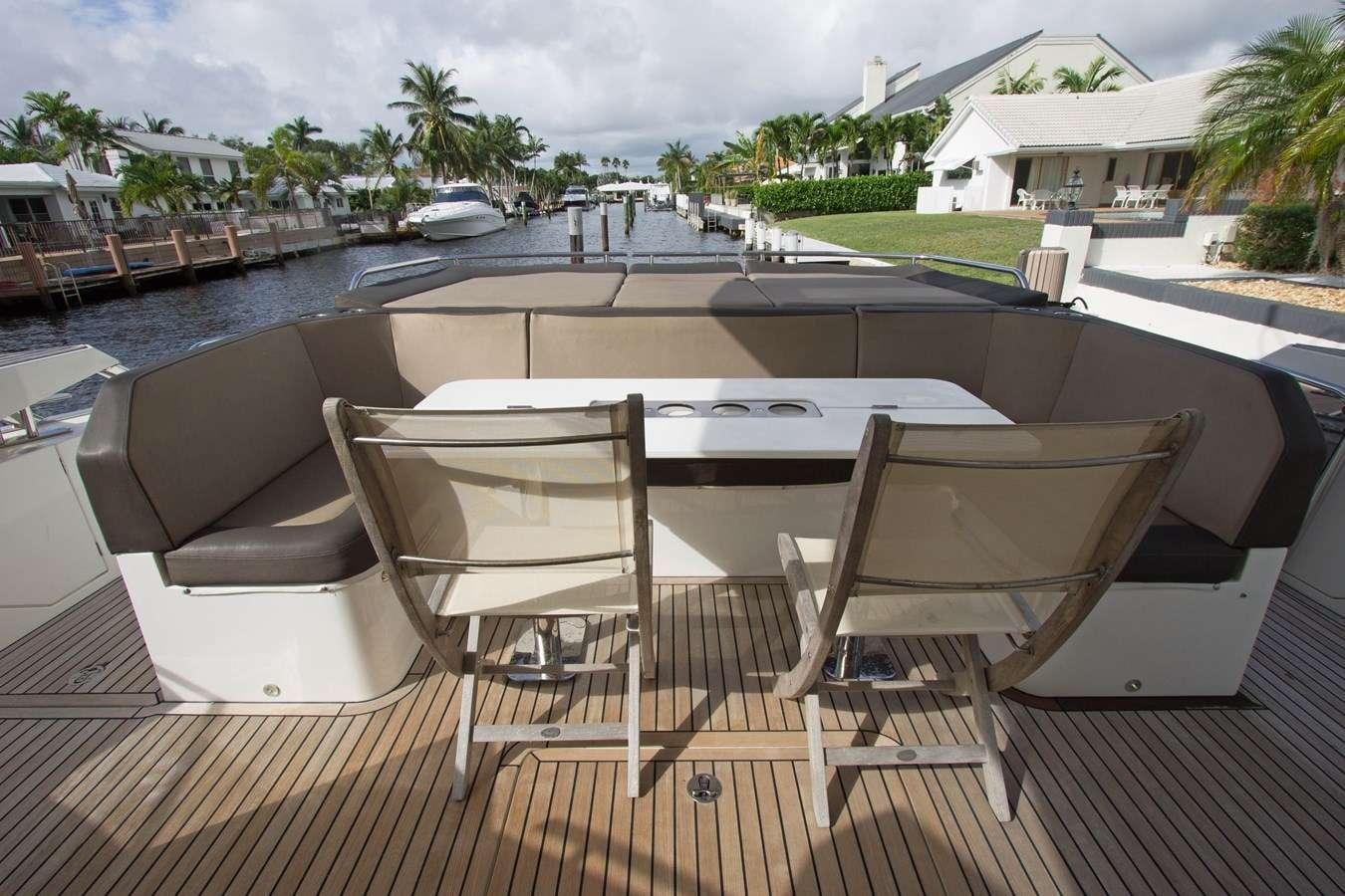 a table and chairs on a deck aboard MOODSWING Yacht for Charter