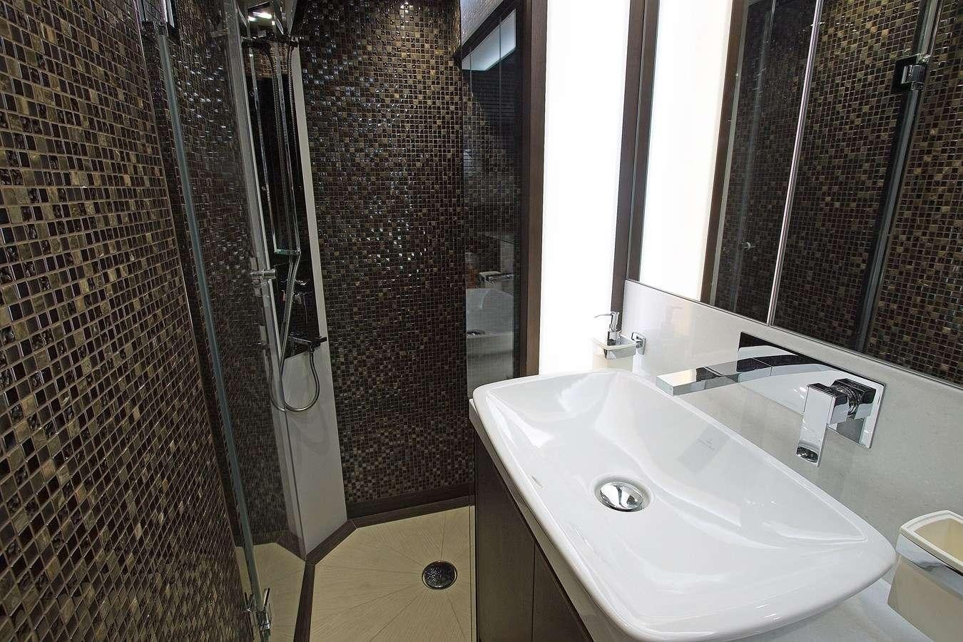 a bathroom with a sink and shower aboard MOODSWING Yacht for Charter