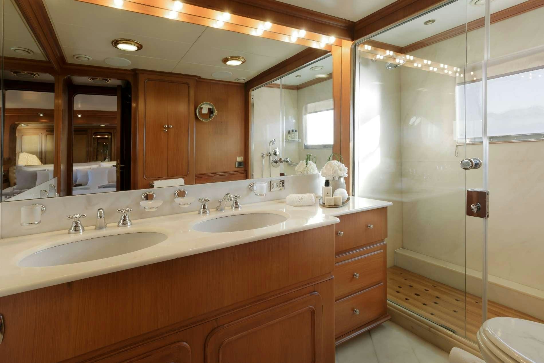 a bathroom with a shower and sinks aboard ESPINOLA Yacht for Charter