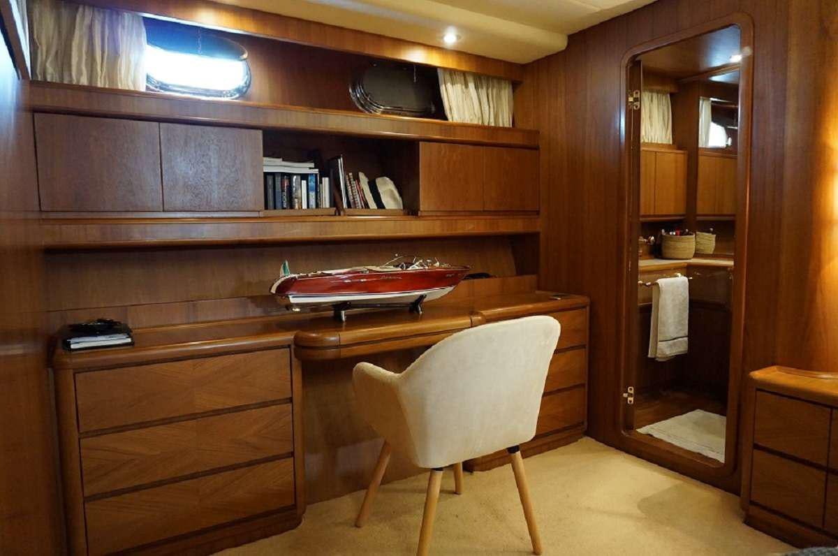 a kitchen with a white chair aboard BALU 3 Yacht for Charter