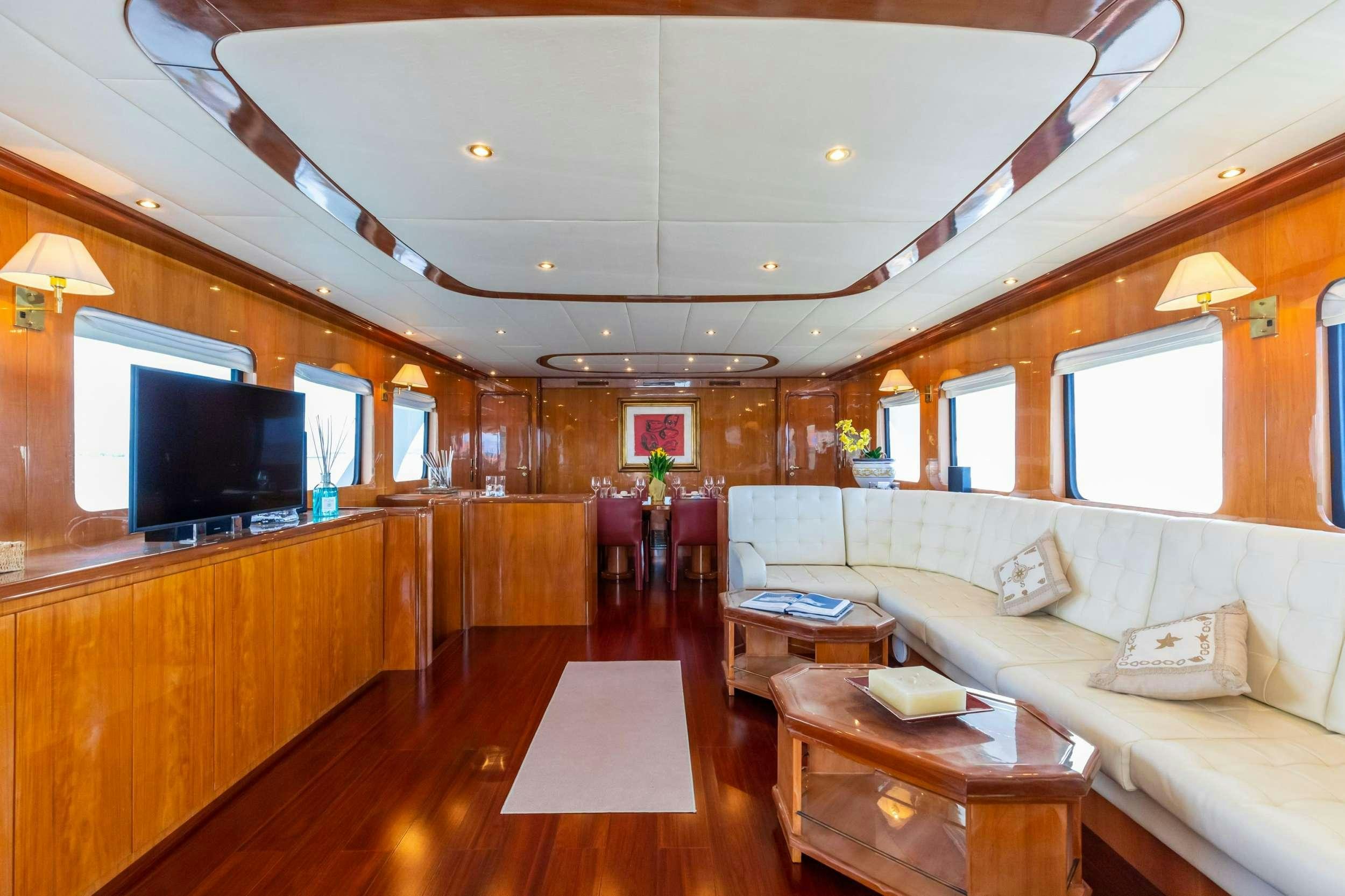 a living room with a couch and a tv aboard SHANGRA Yacht for Charter