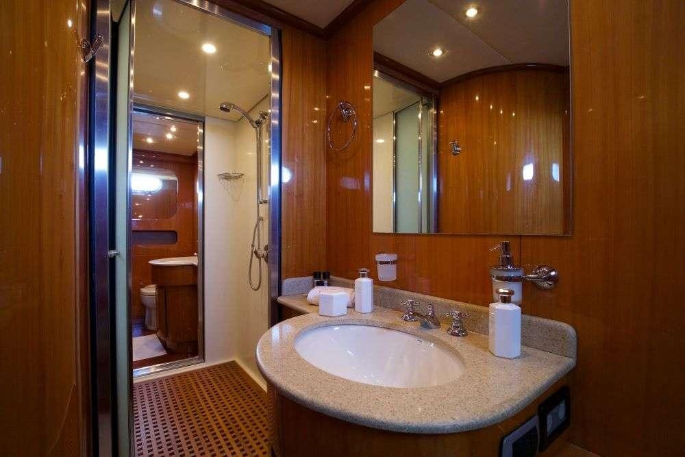 a bathroom with a sink and a mirror aboard SHANGRA Yacht for Charter