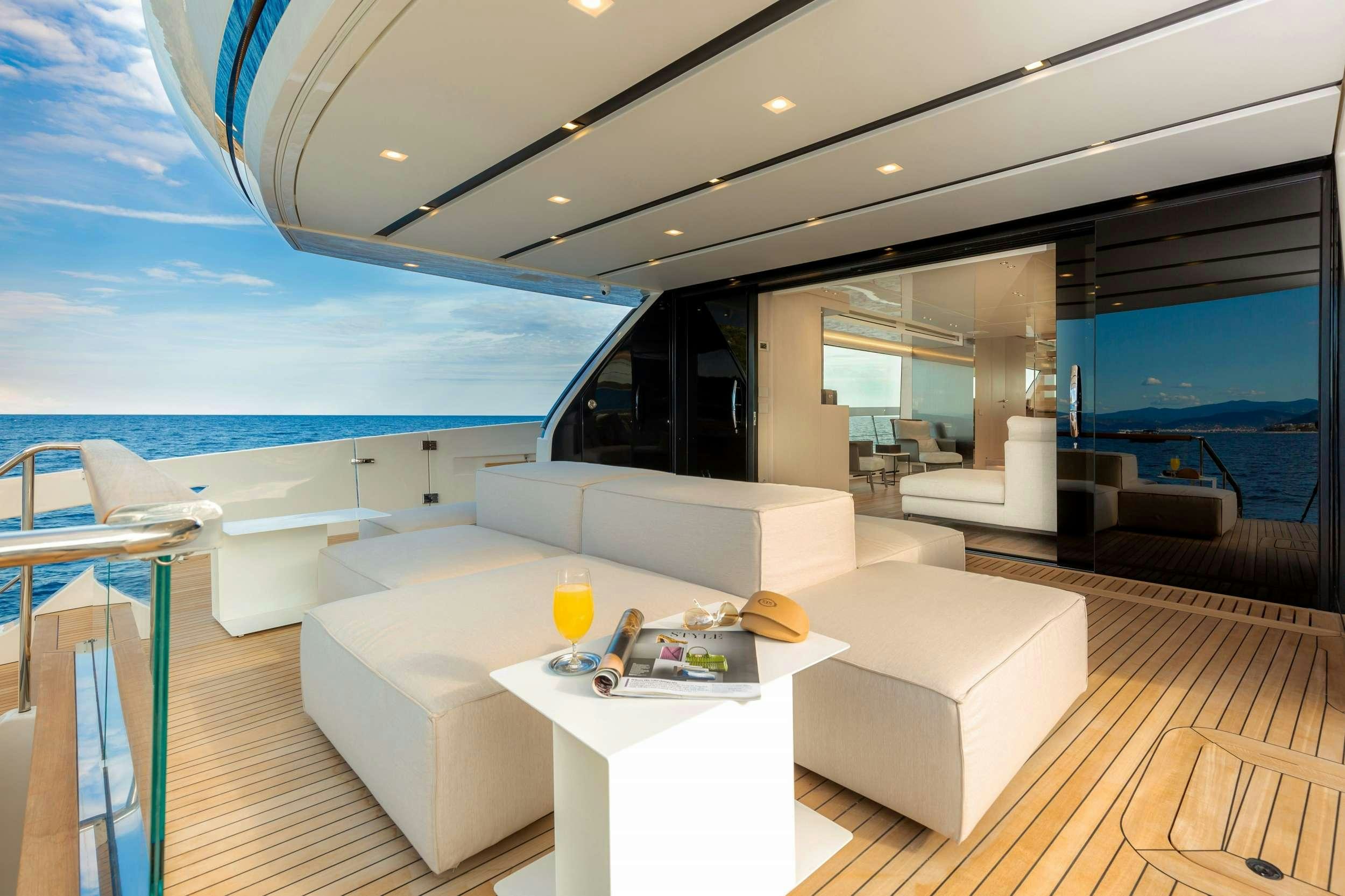 a modern living room with a large balcony aboard K1 Yacht for Charter