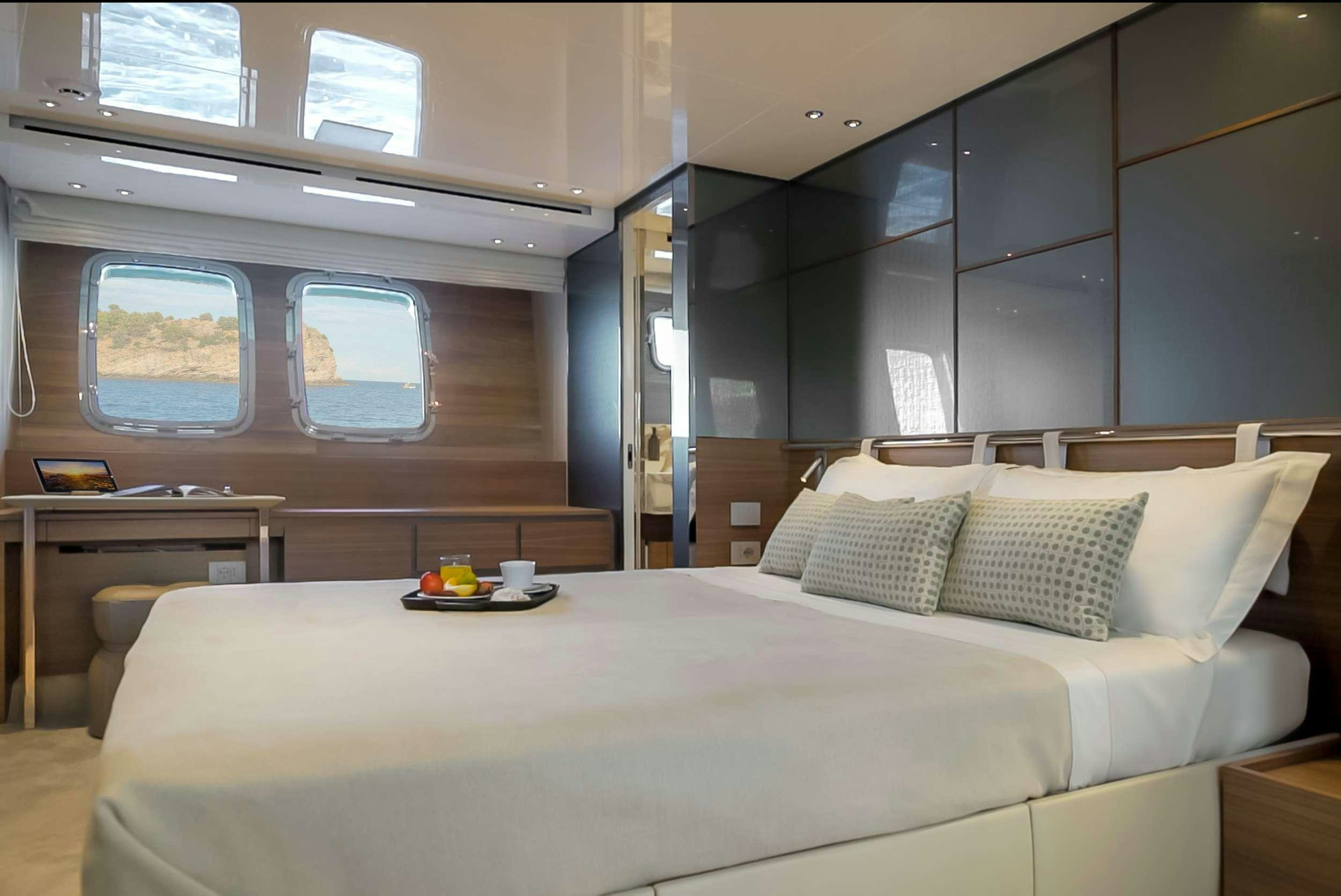 a bed with a tray of food aboard K1 Yacht for Charter