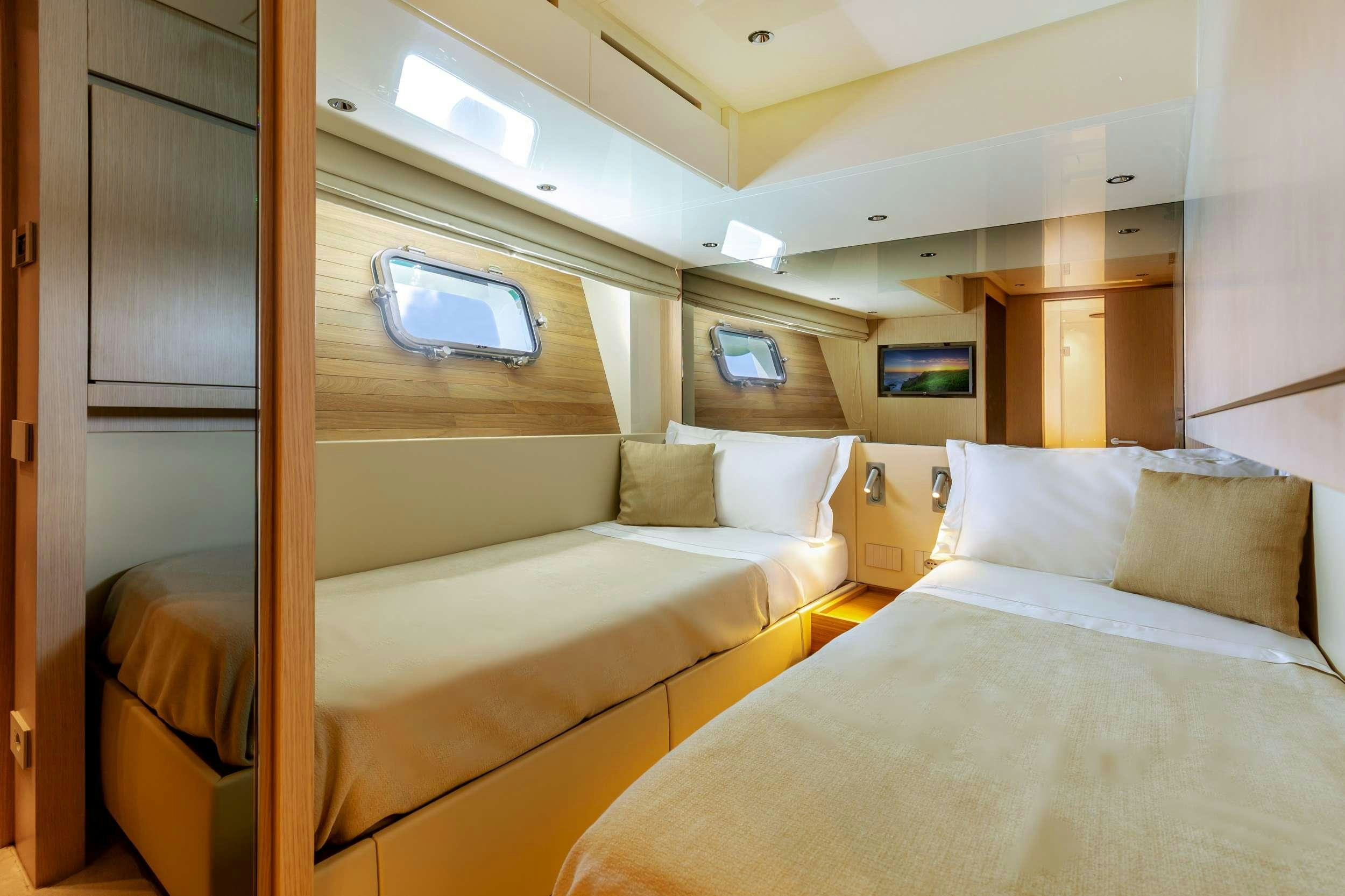 a room with a bed and a window aboard K1 Yacht for Charter