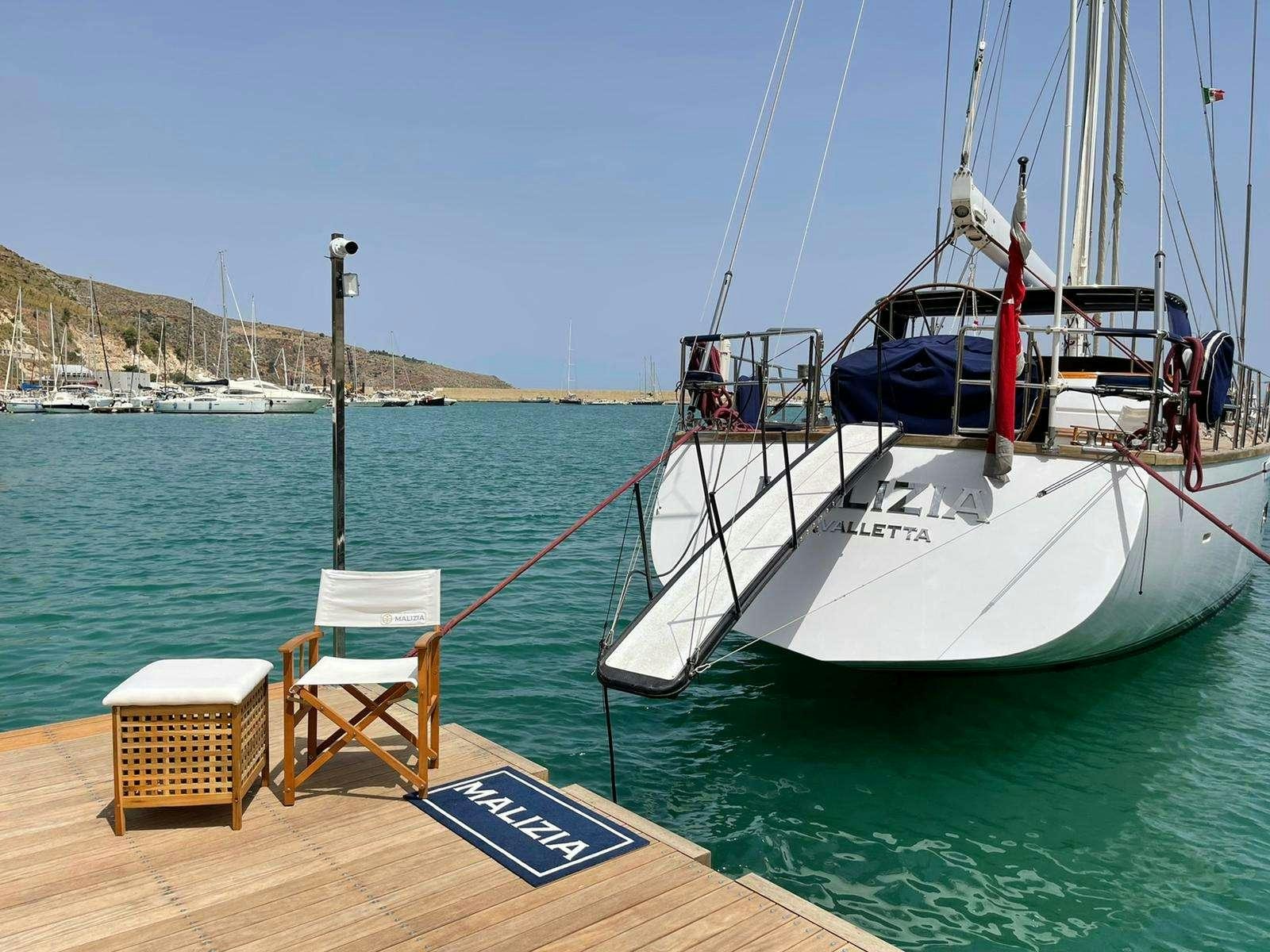 a boat tied to a dock aboard MALIZIA Yacht for Charter