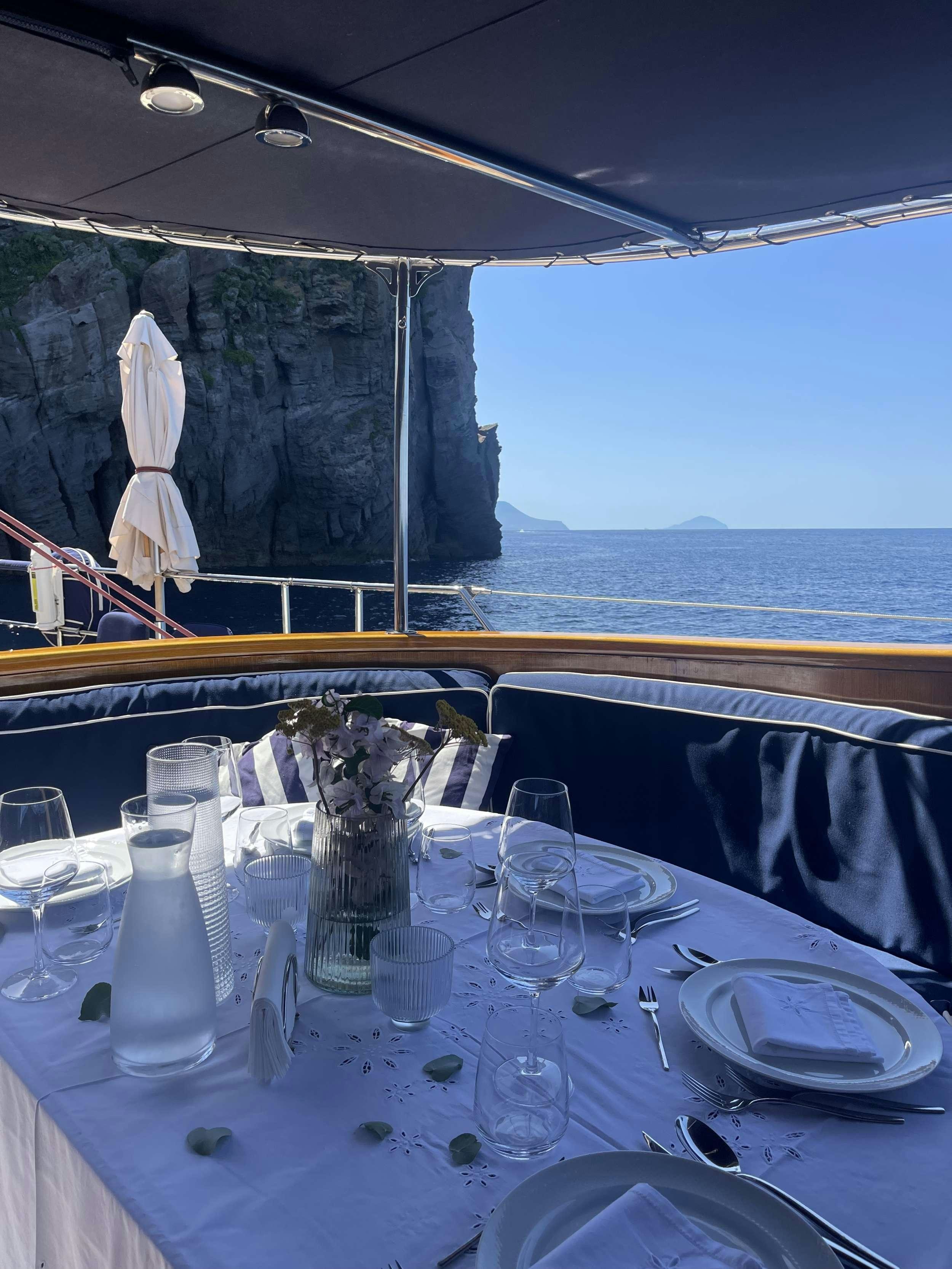 a table set for a dinner aboard MALIZIA Yacht for Charter