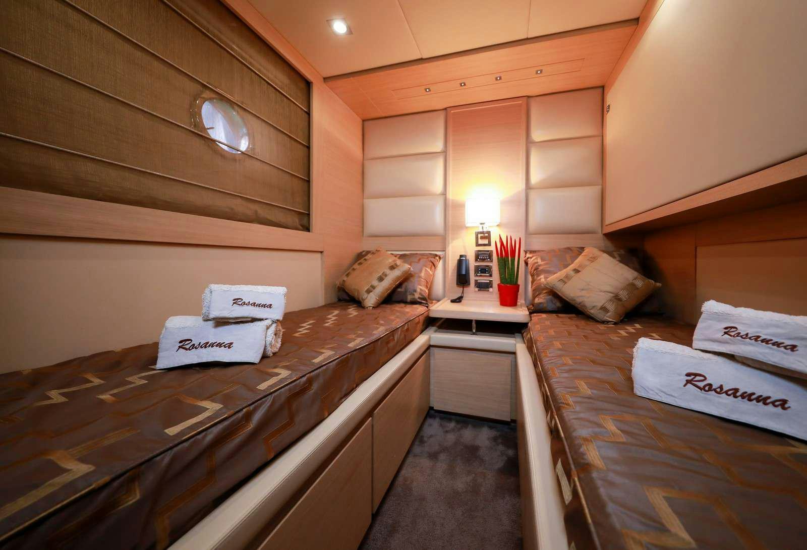 a room with a bed and a desk aboard FOR EVER ROSANNA Yacht for Charter