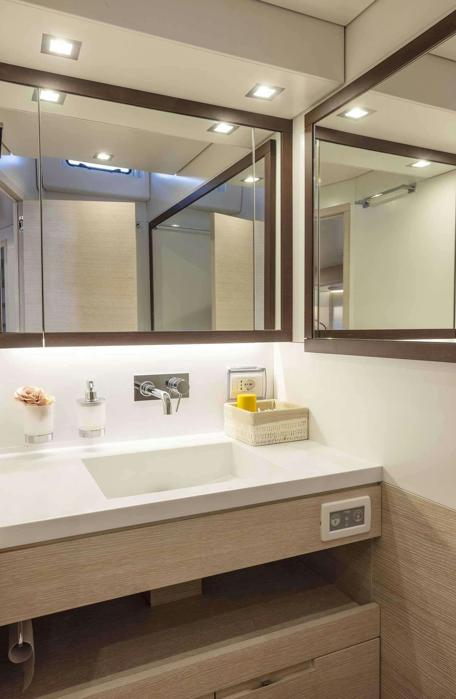 a bathroom with a large mirror aboard MINDFULNESS Yacht for Charter
