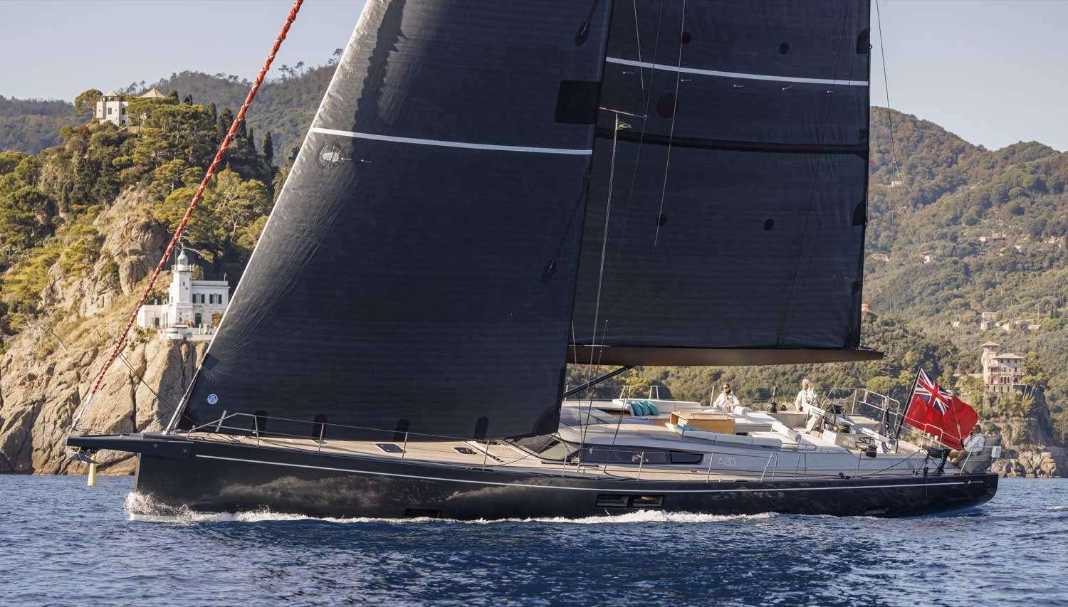 a large black boat on the water aboard MINDFULNESS Yacht for Charter
