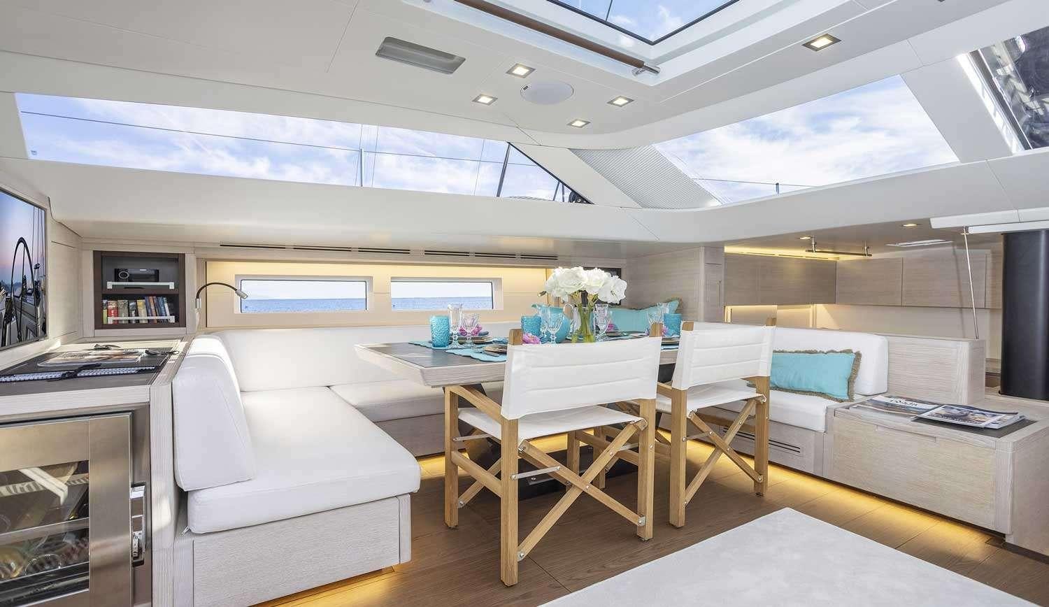 a room with a table and chairs aboard MINDFULNESS Yacht for Charter
