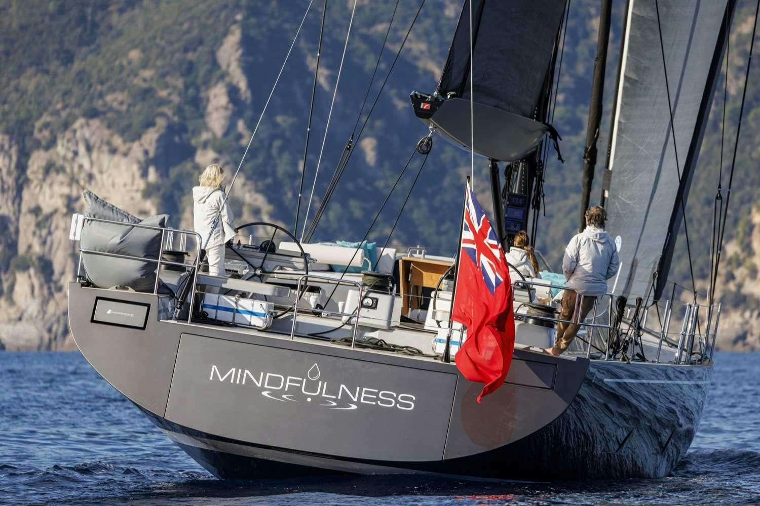a boat with a flag on it aboard MINDFULNESS Yacht for Charter