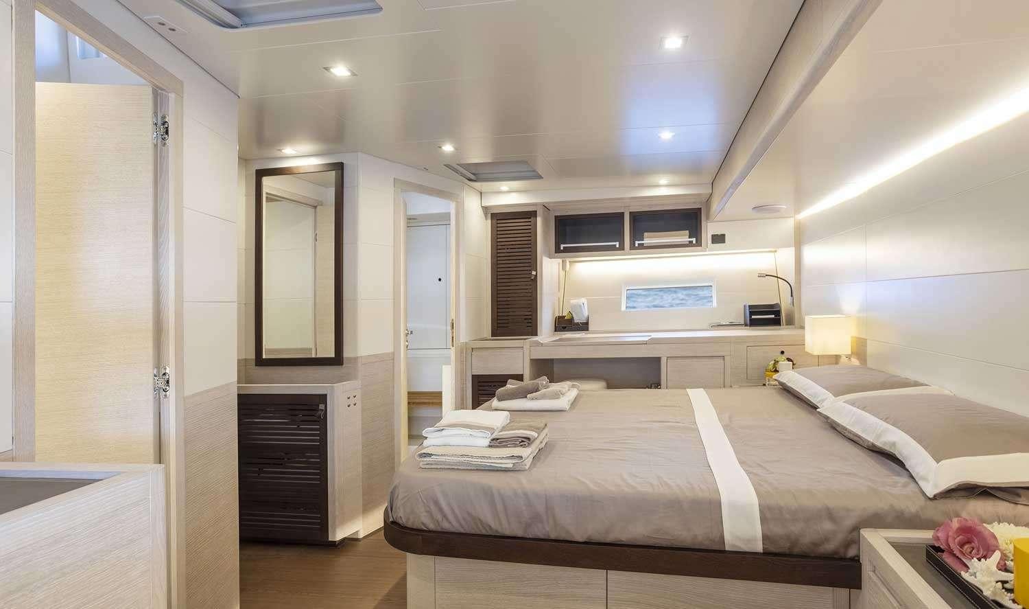 a bedroom with a bed and a desk aboard MINDFULNESS Yacht for Charter