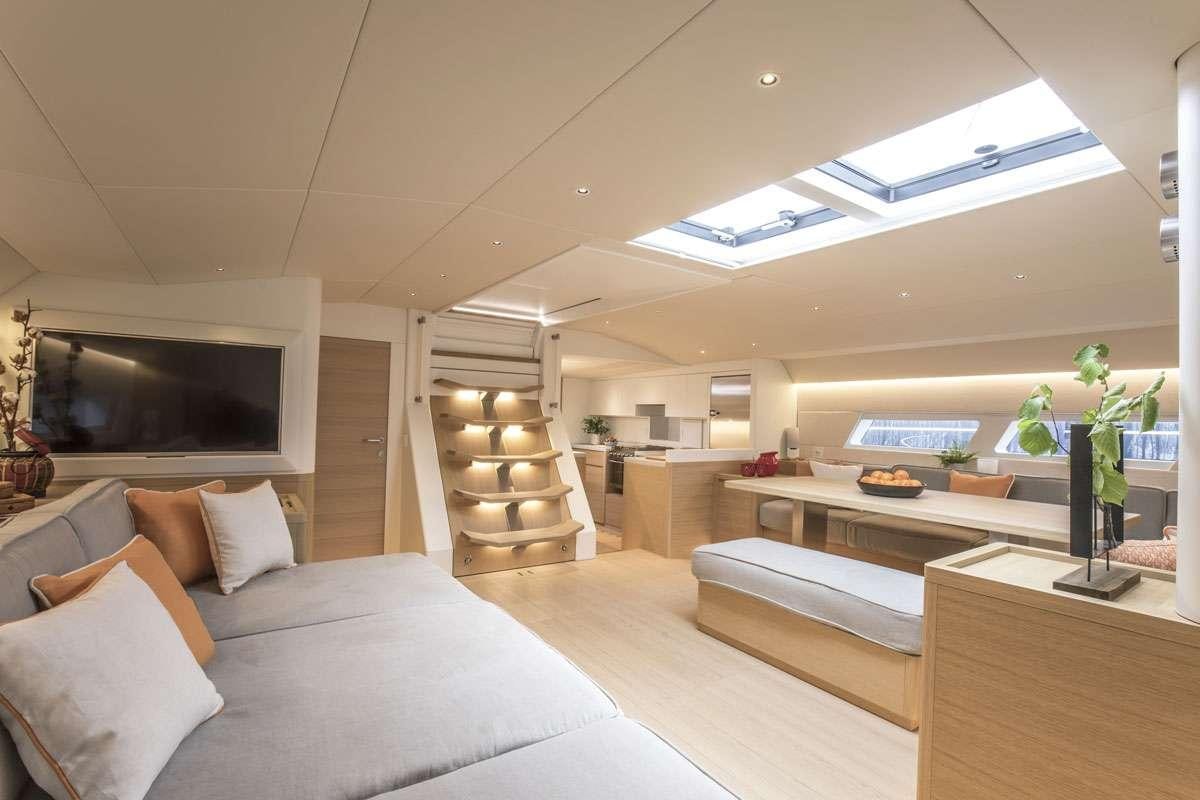 a living room with a large white sofa and a fireplace aboard KARMA Yacht for Charter