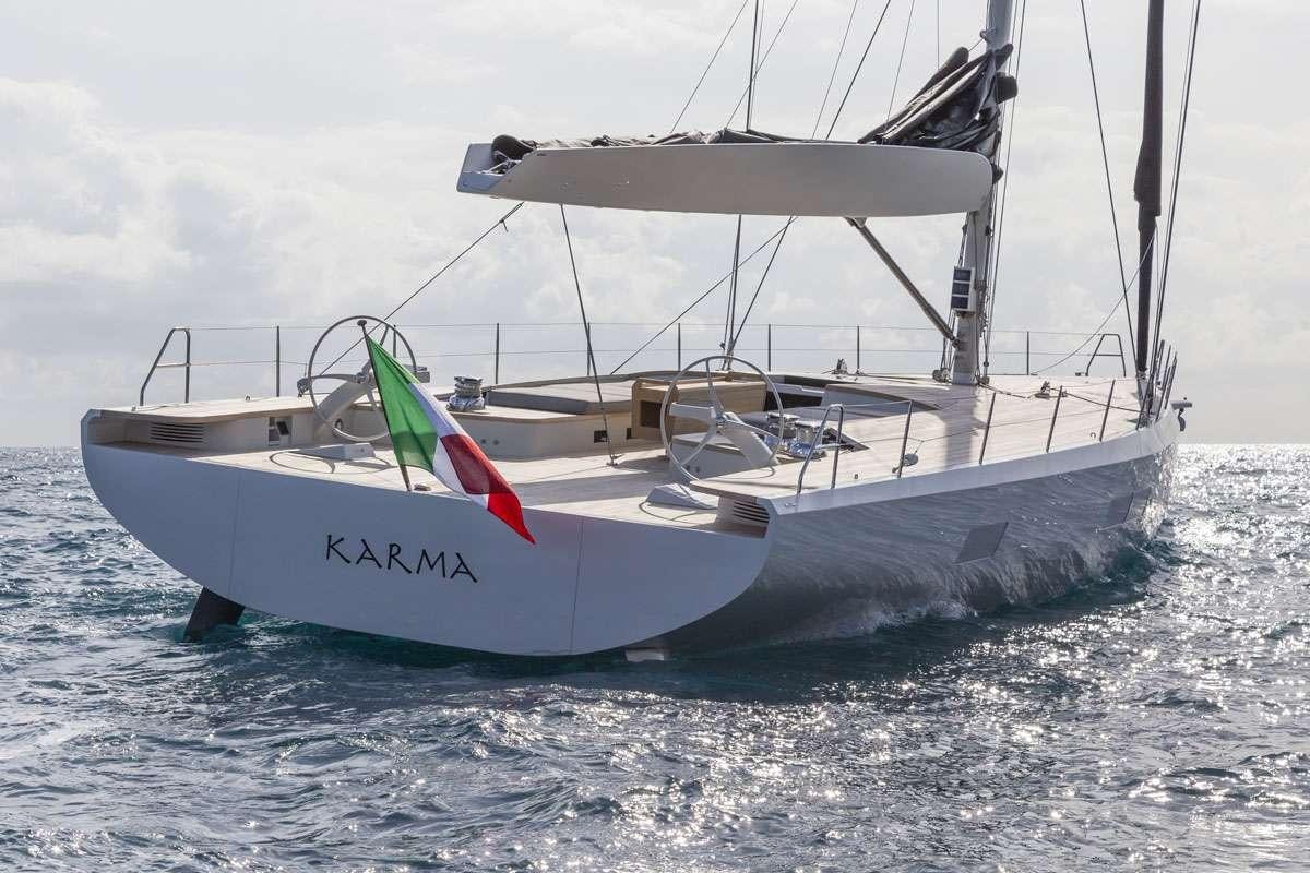 a boat with a flag on it aboard KARMA Yacht for Charter