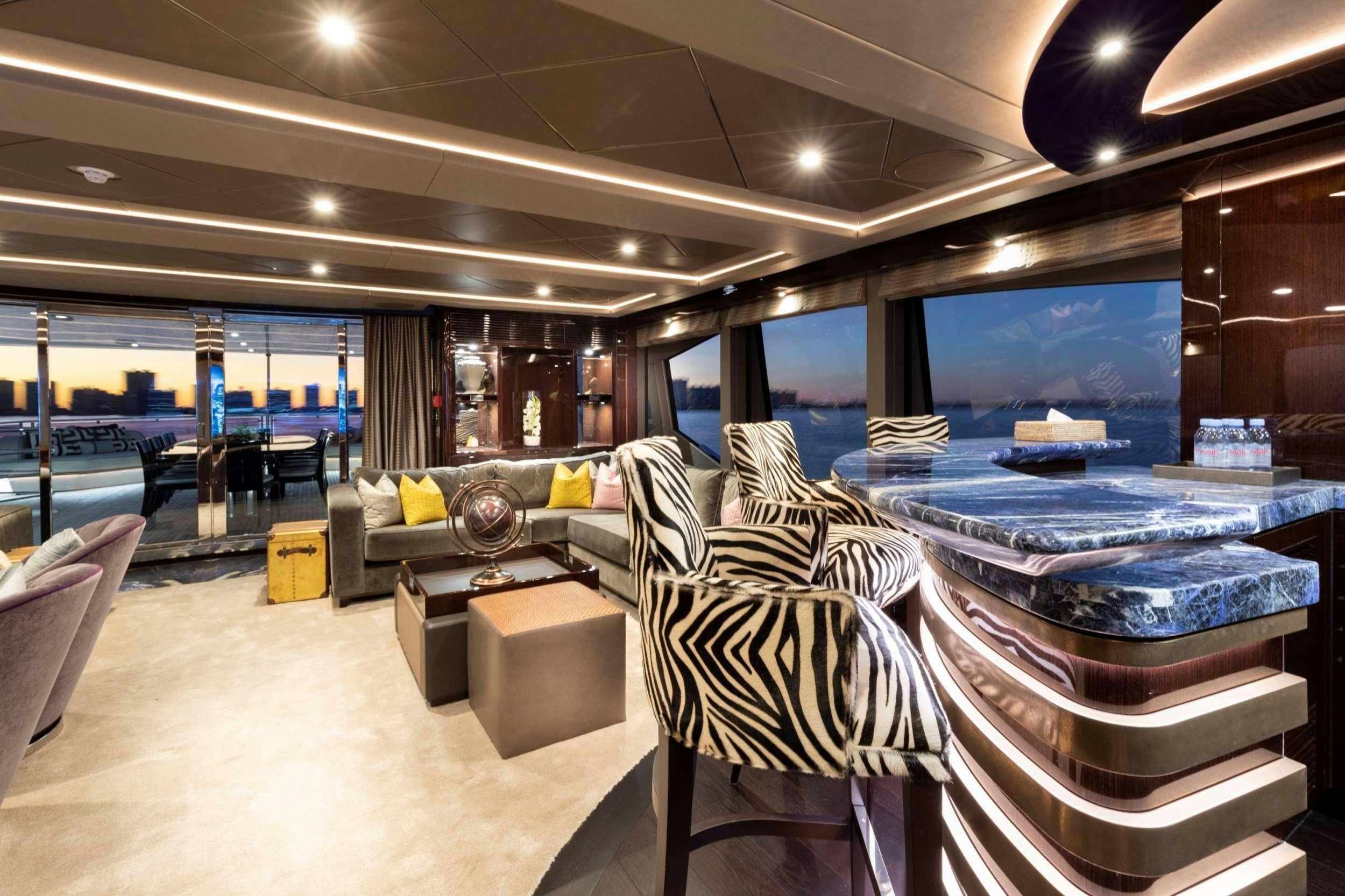 a room with a table chairs and a large window aboard EXODUS Yacht for Charter