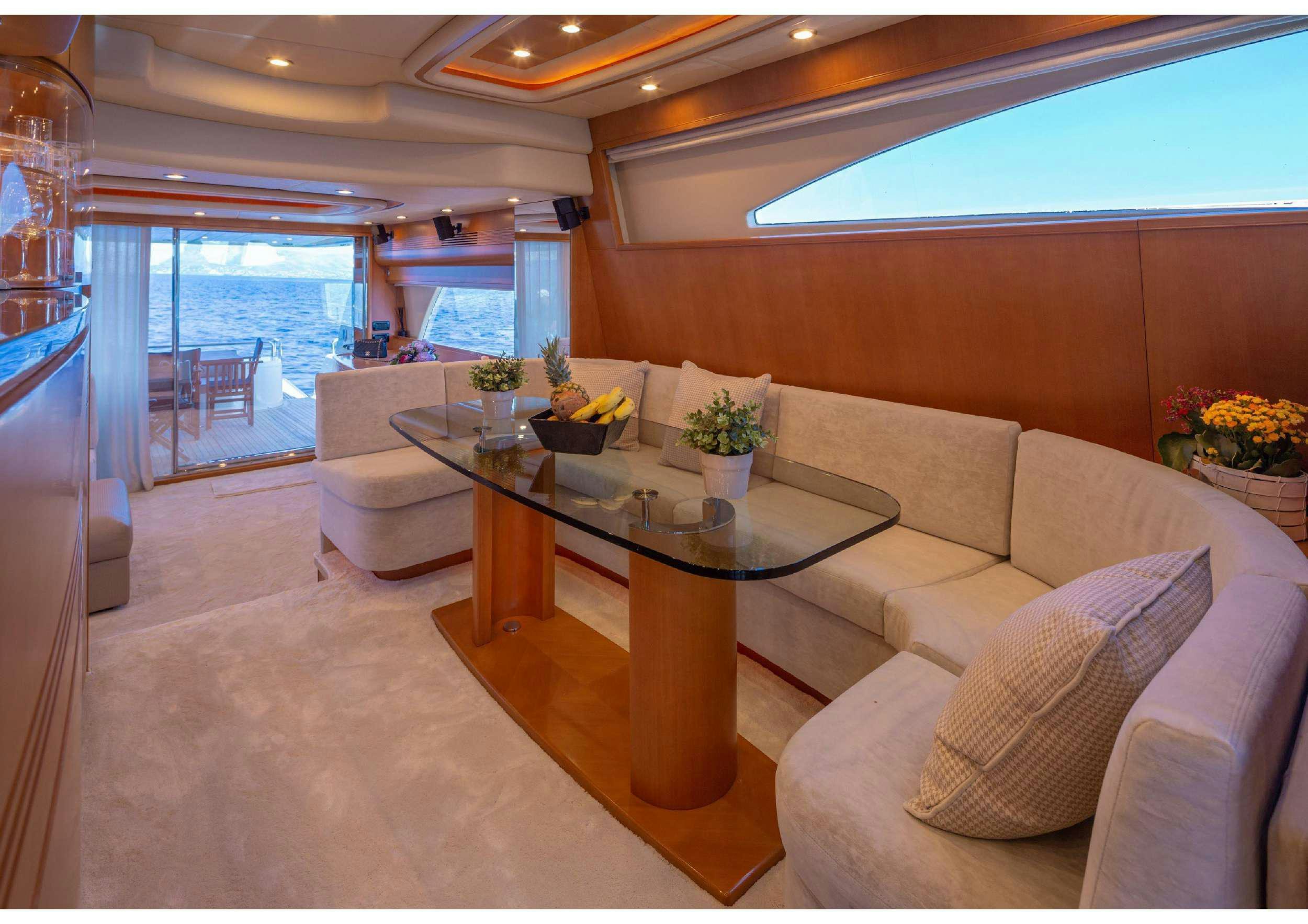 a living room with a table and chairs aboard LEGEND Yacht for Charter